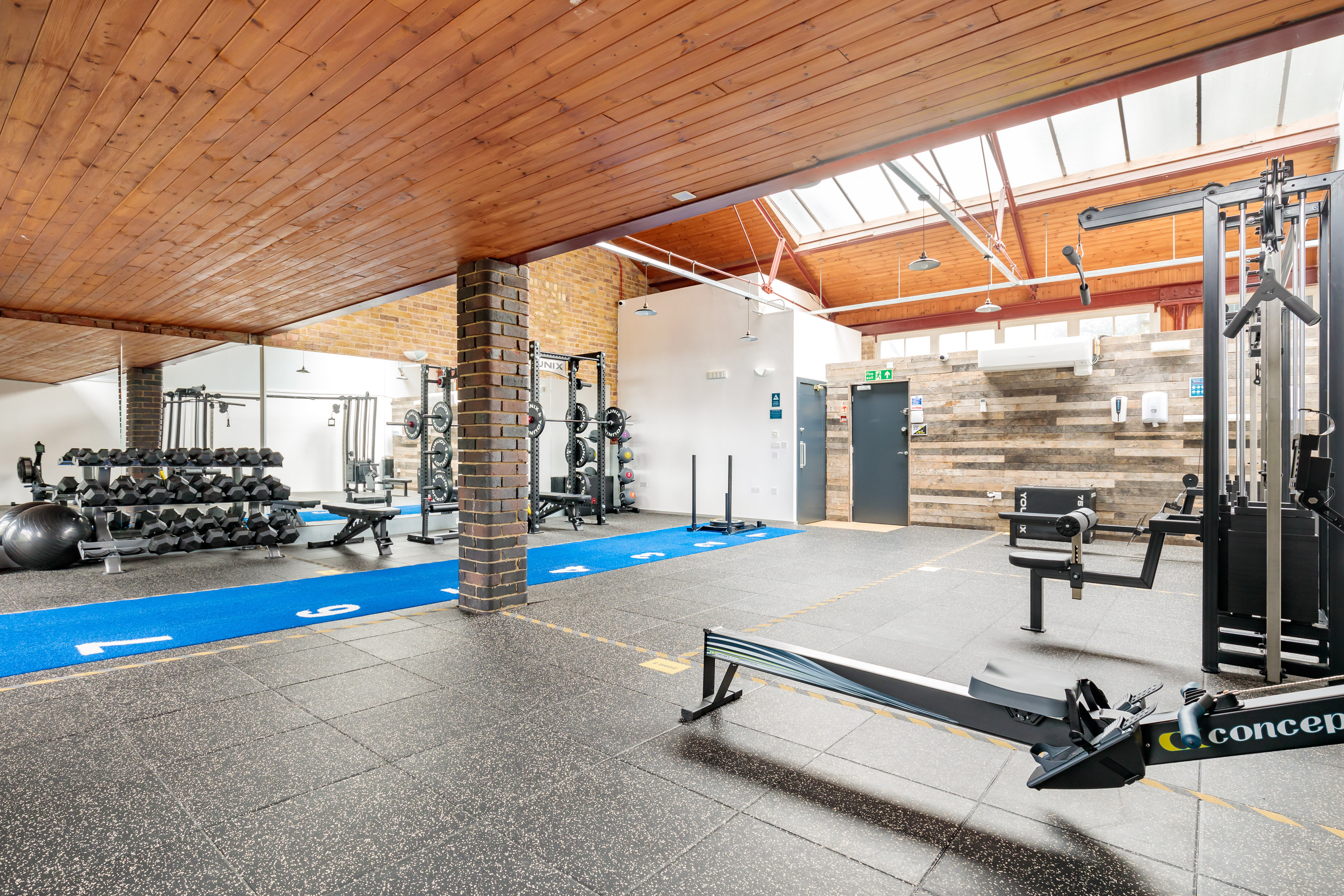 Well-equipped fitness venue with natural light for wellness retreats and team-building events.