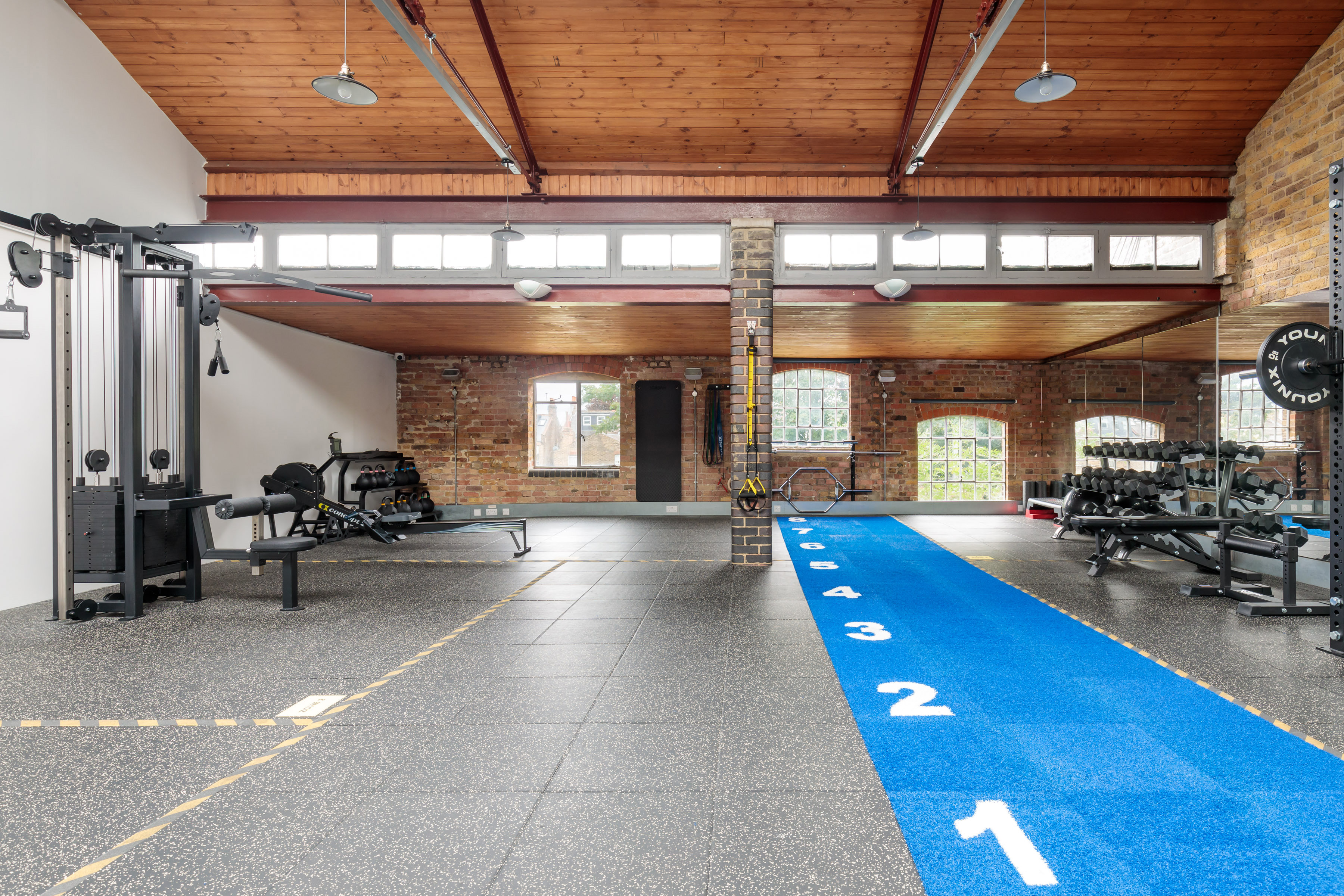 Versatile fitness venue with modern equipment for corporate wellness events and team-building.