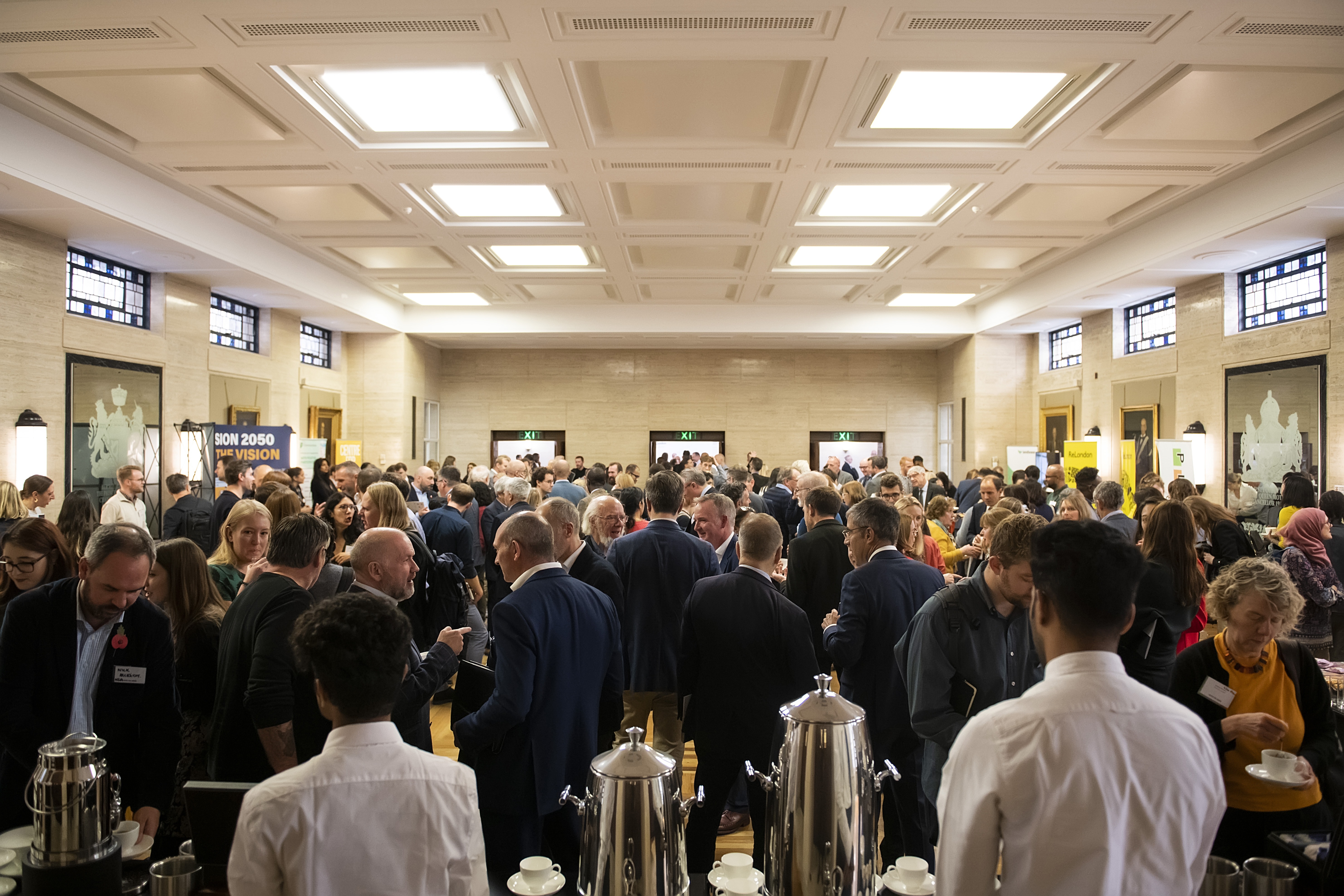 Networking event at MacMillan Hall, University of London, with attendees engaging and conversing.