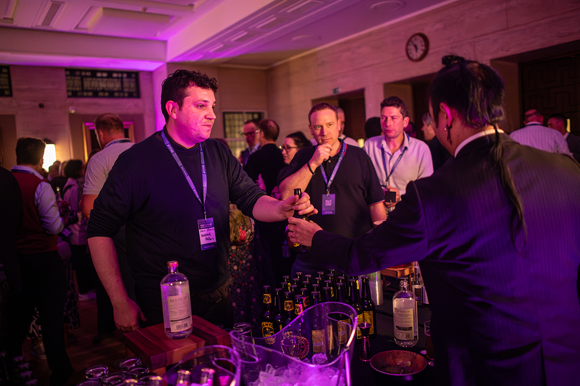 Networking event at MacMillan Hall, University of London, featuring stylish bar and name badges.