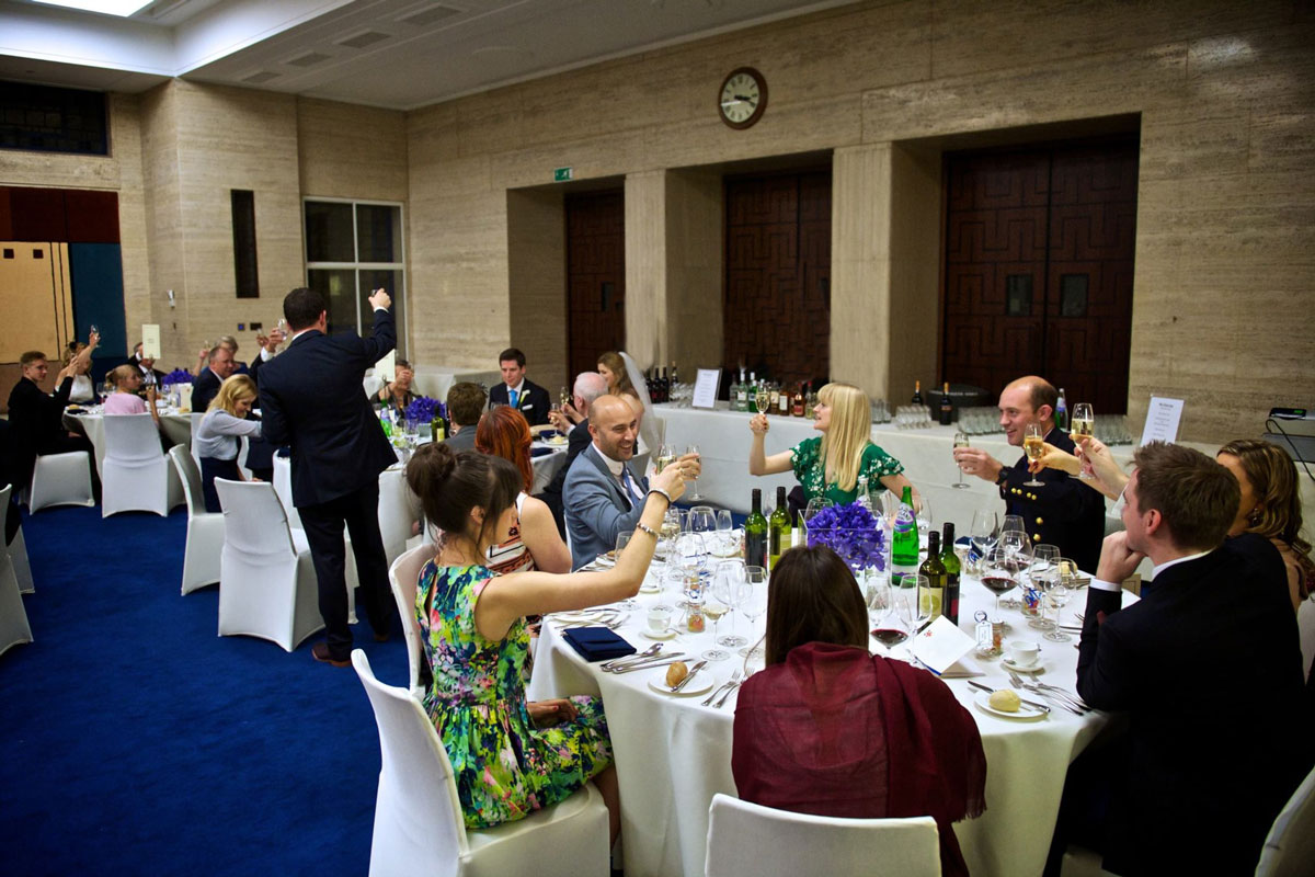 Elegant dinner event at MacMillan Hall, University of London, with floral centerpieces.