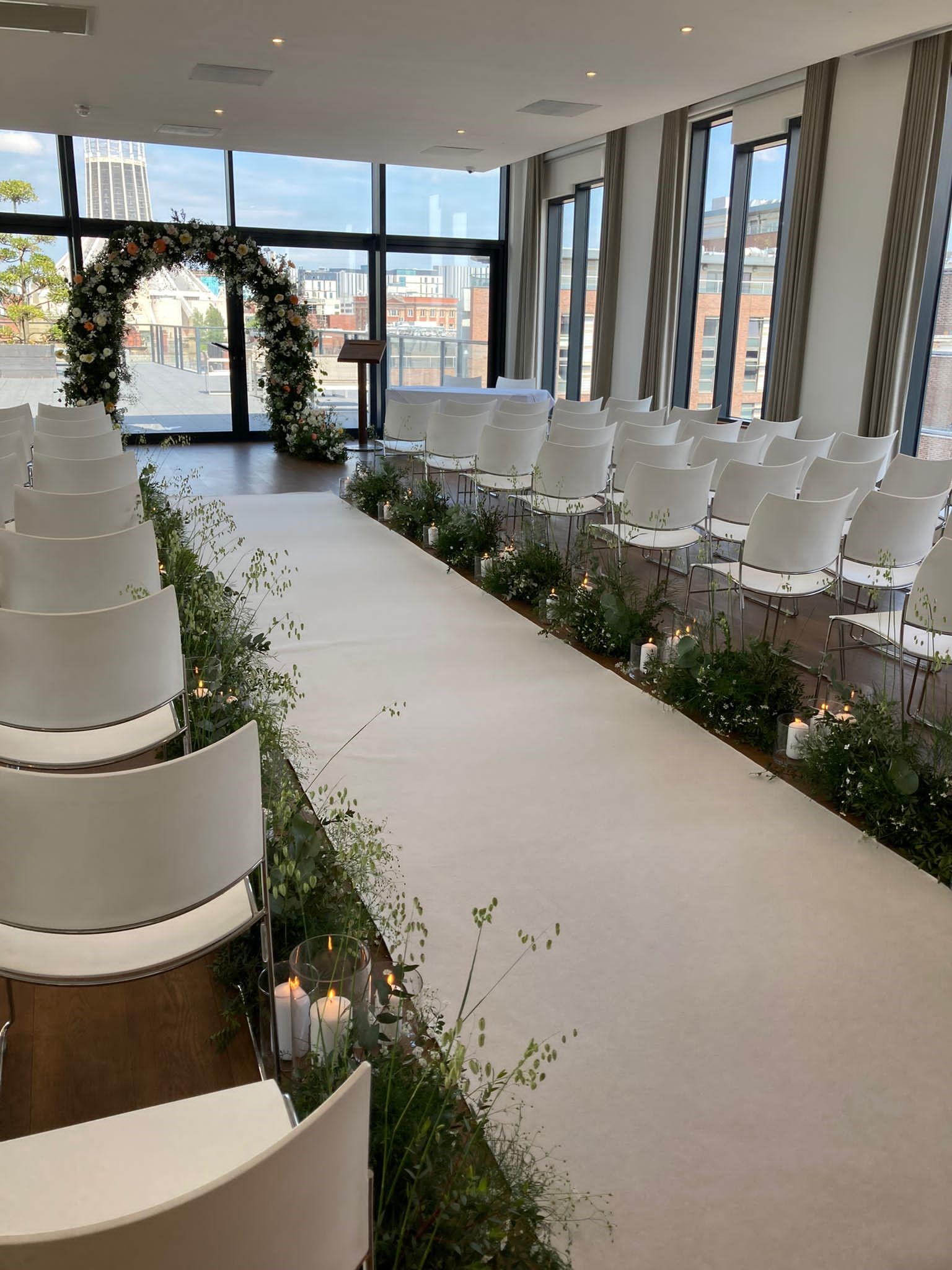Elegant wedding ceremony space at Hope Street Hotel with greenery and candles.