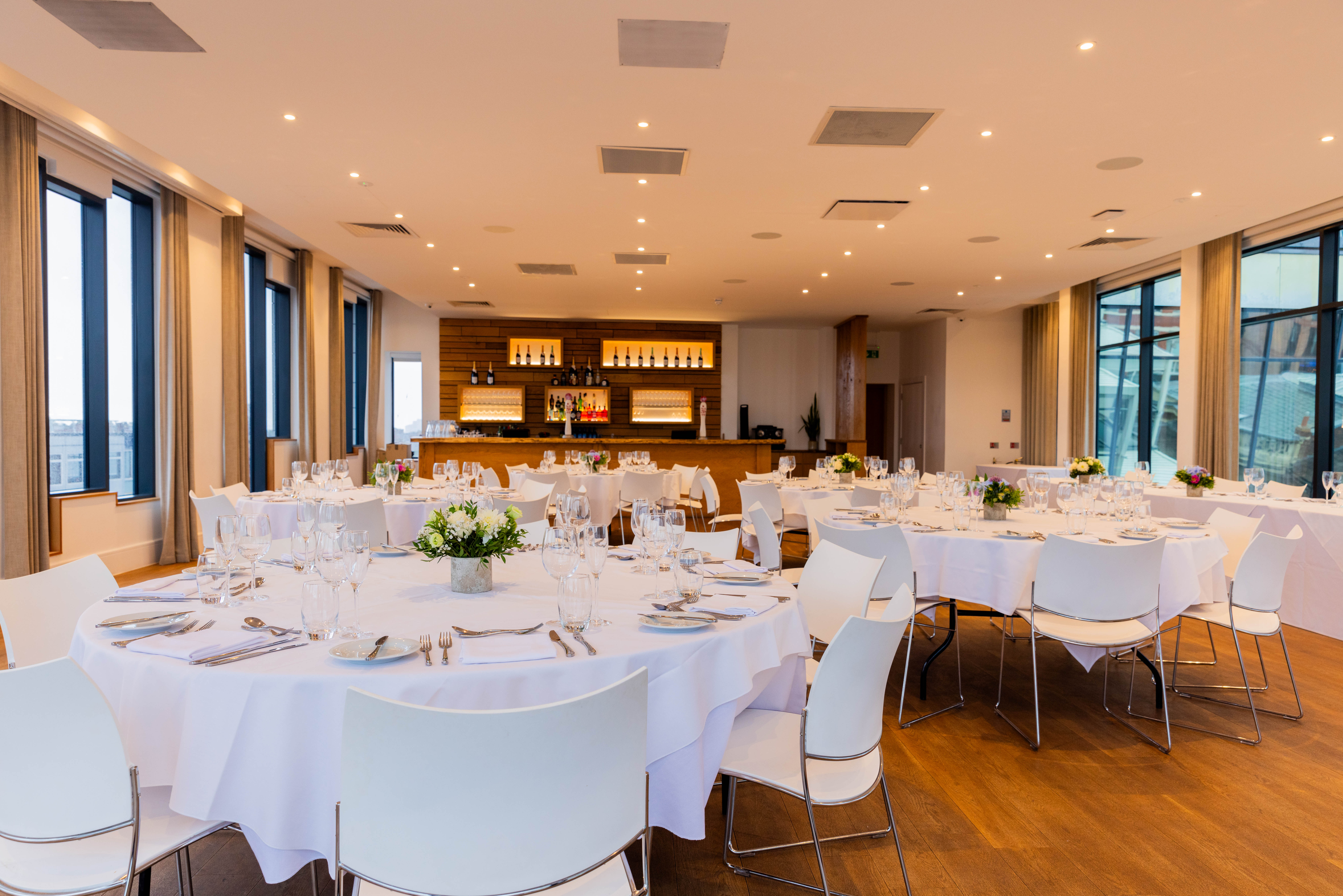 Elegant event space at Hope Street Hotel with round tables for corporate meetings.