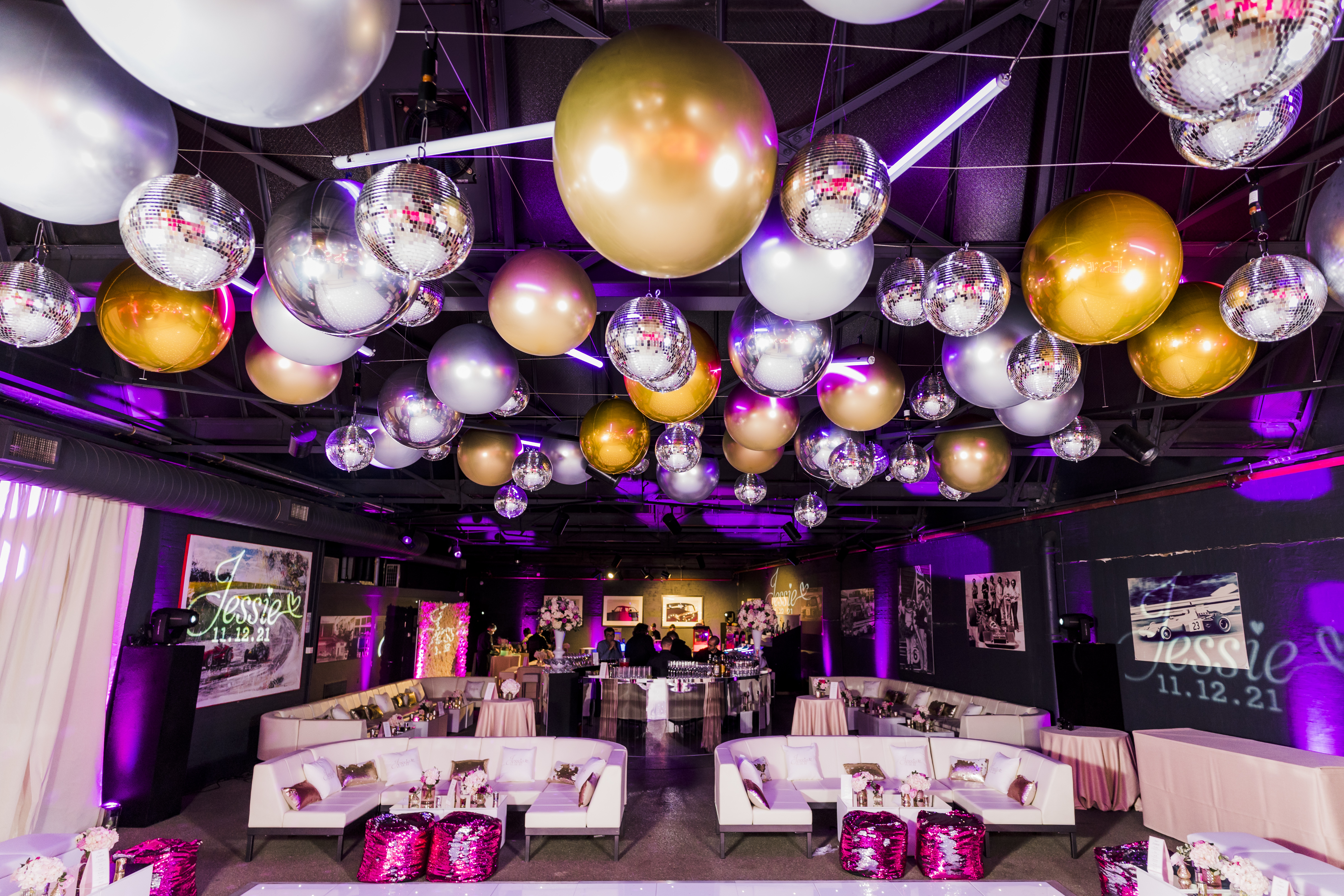Vibrant event space with metallic balloons and disco balls for stylish celebrations.