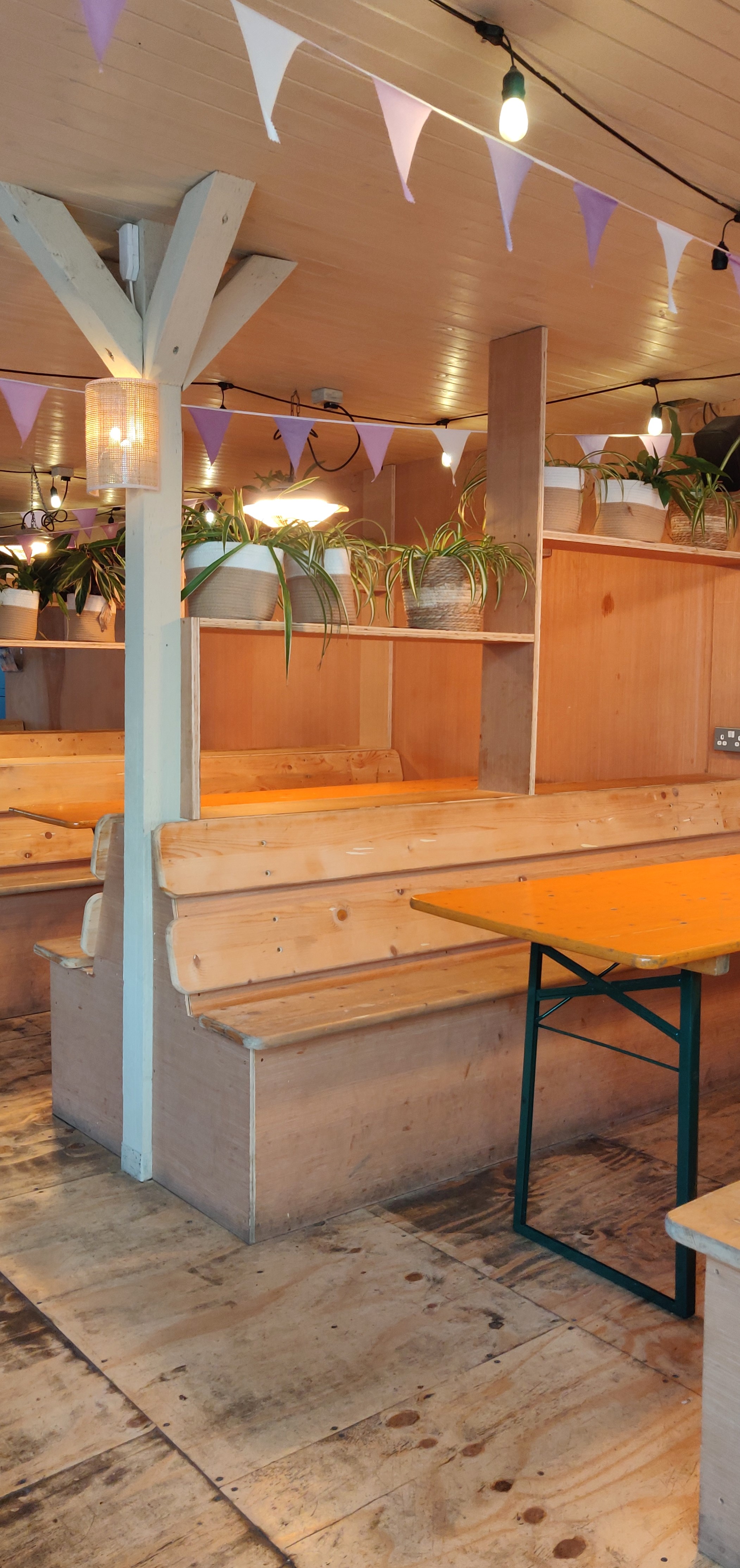 Cozy Log Cabin meeting space in Hackney Bridge with wooden benches for informal gatherings.