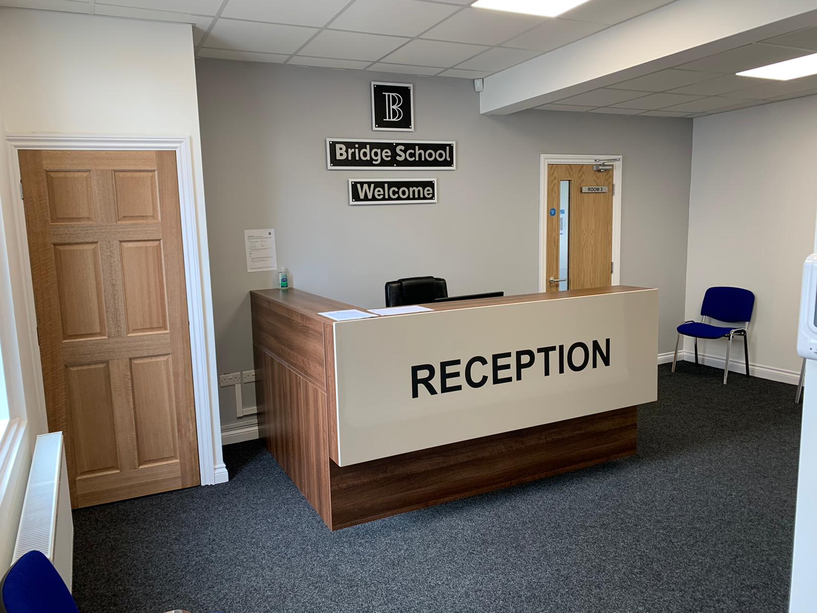 Modern reception area in Meeting Room 1, Bridge School of Excellence for events.