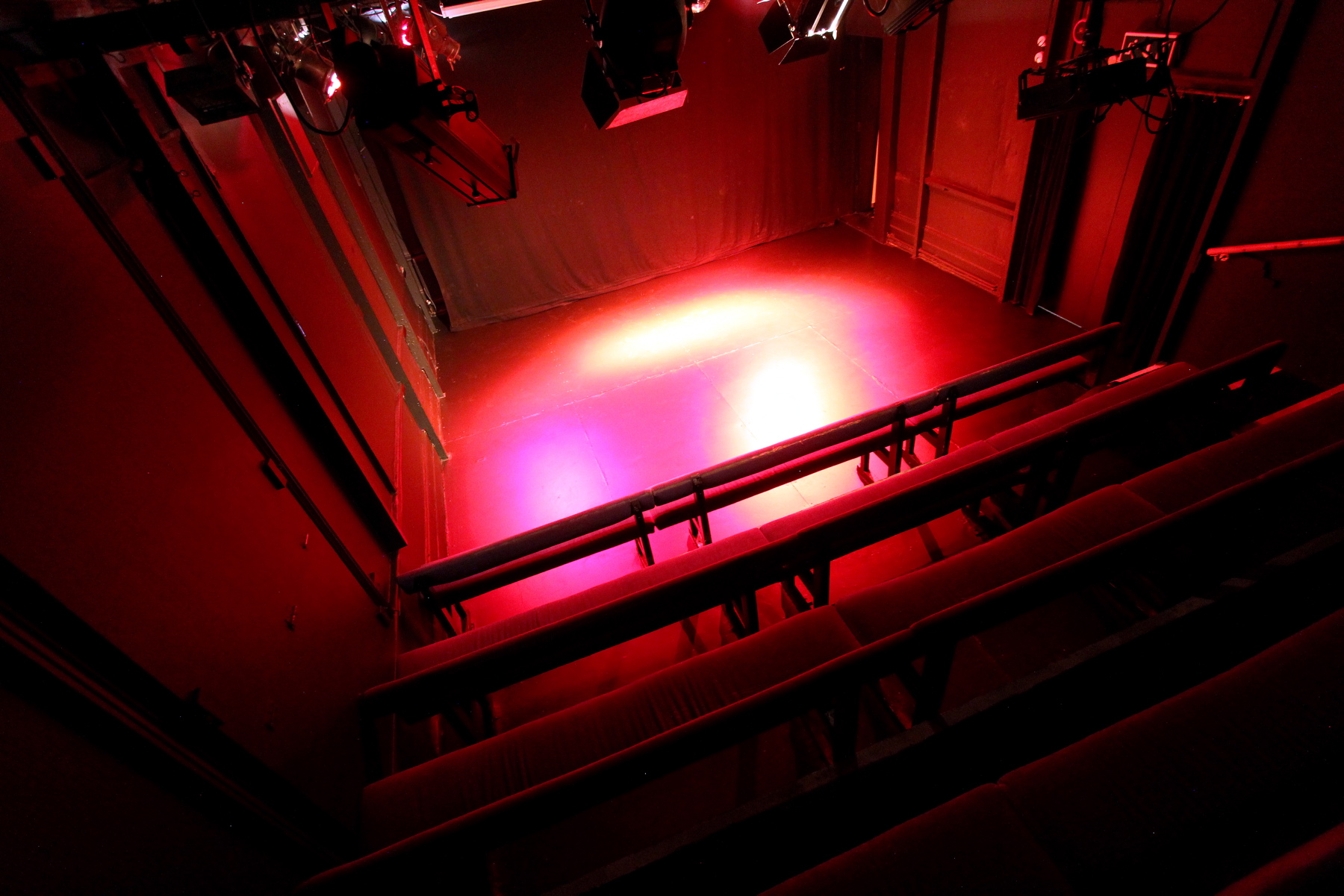 Black Box Theatre with red lighting, ideal for intimate performances and events.