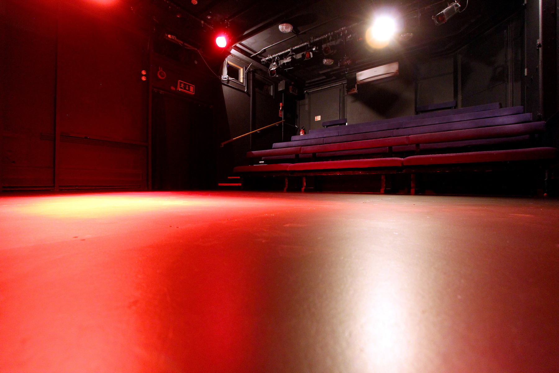 Black Box Theatre at Etcetera Theatre with polished floor, ideal for intimate performances.