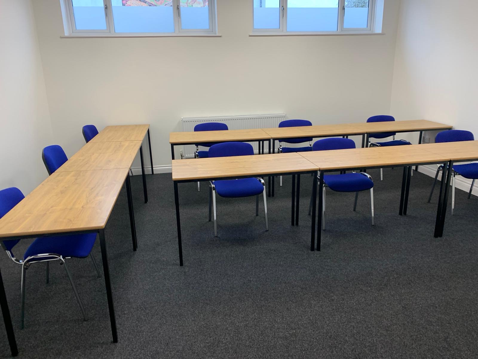 Meeting Room 3 at Bridge School: U-shaped tables and blue chairs for engaging discussions.