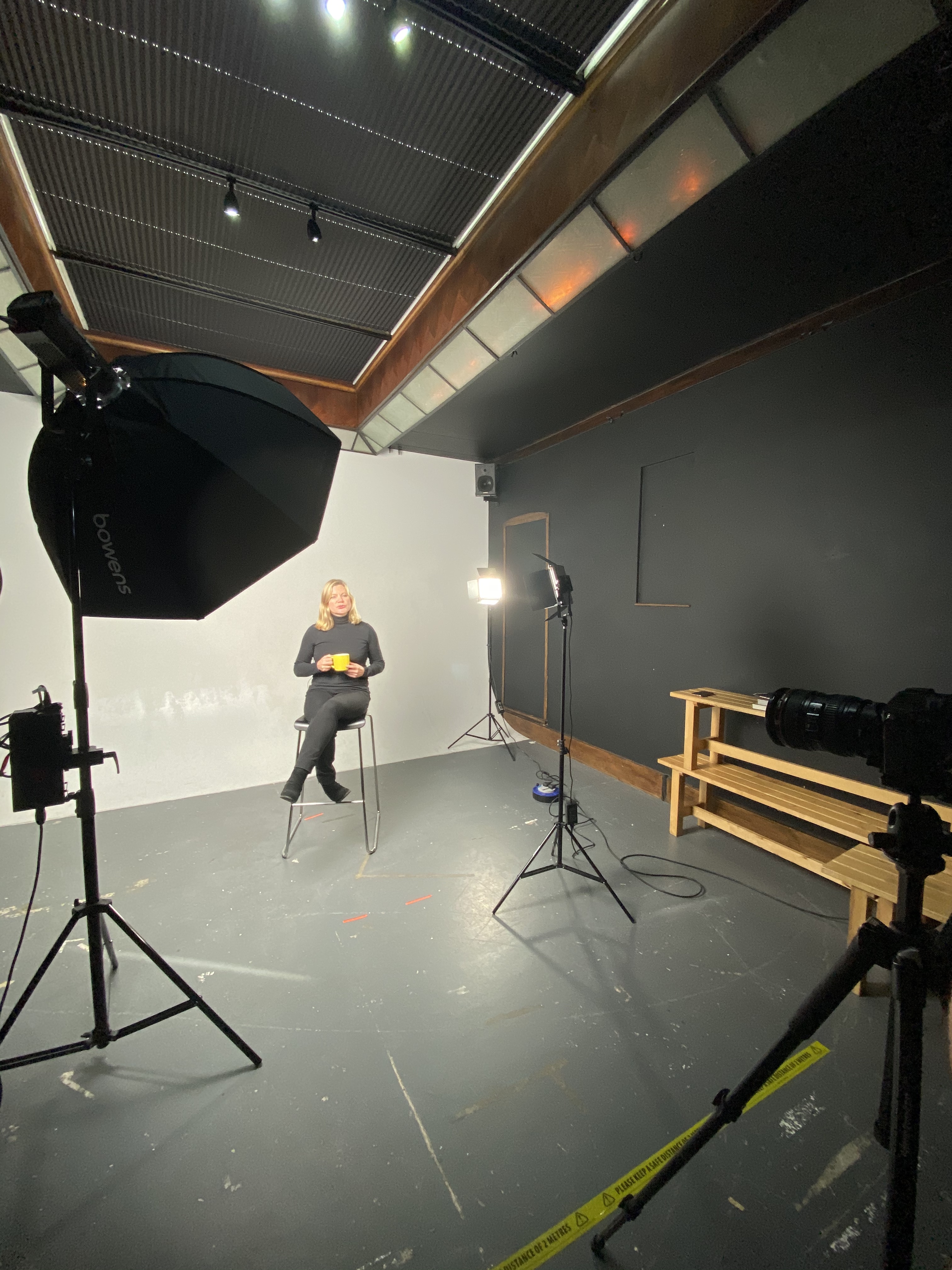 Professional video shoot setup with minimalist backdrop and lighting for interviews.