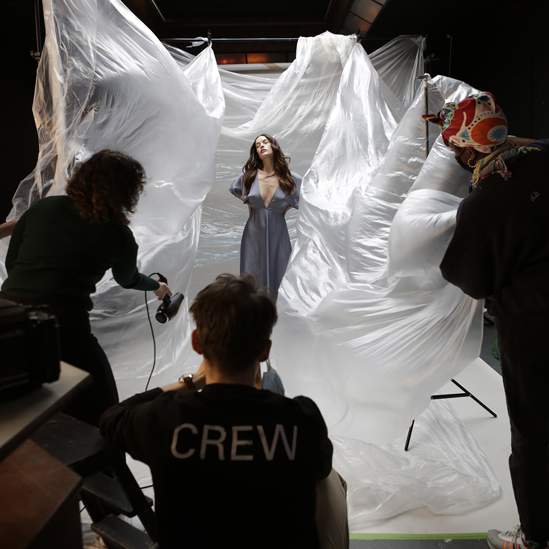 Dynamic event photoshoot with flowing materials showcasing teamwork and creativity.