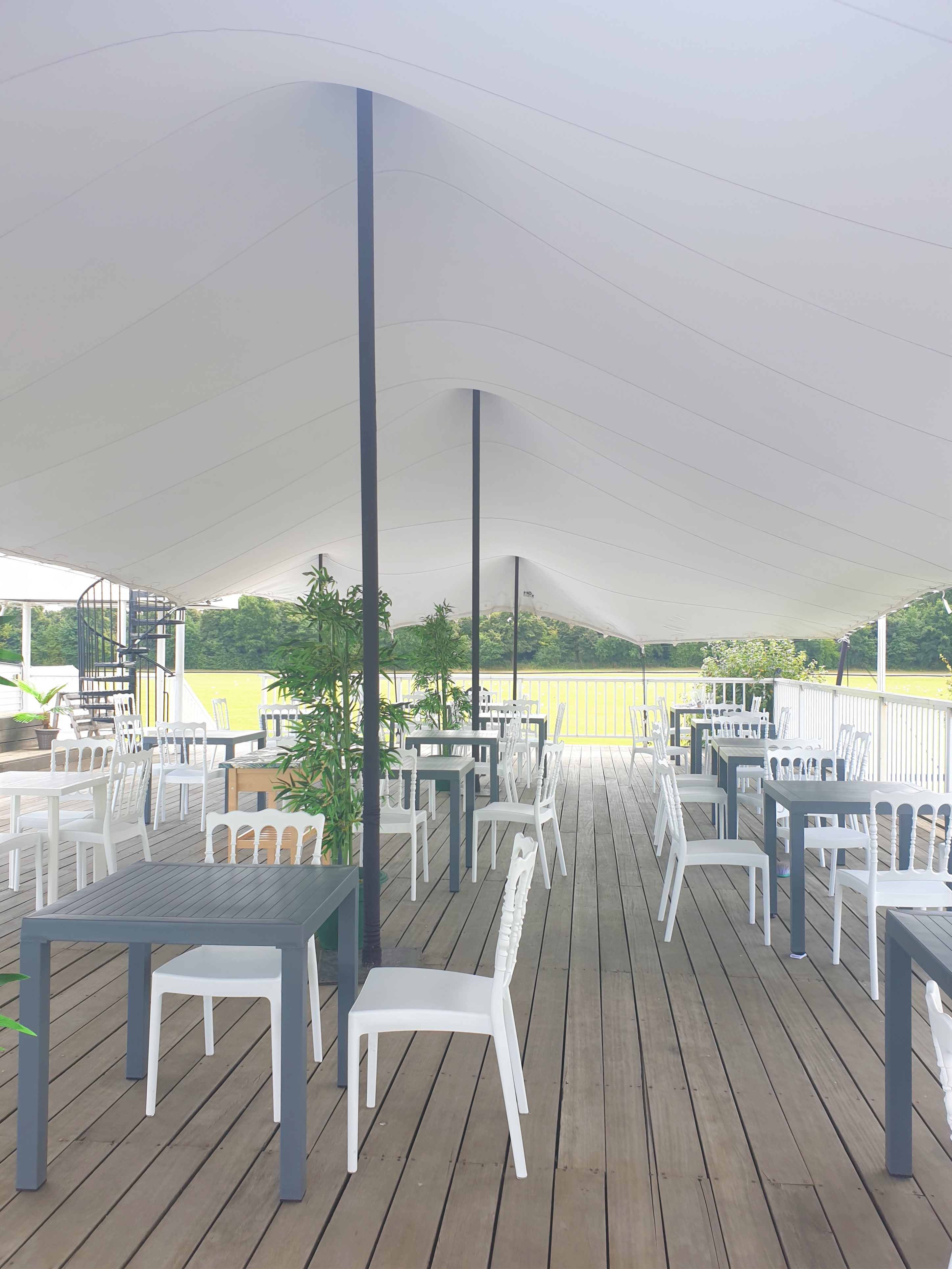 Rooftop Terrace at Ham Polo Club: modern outdoor event space with greenery for gatherings.
