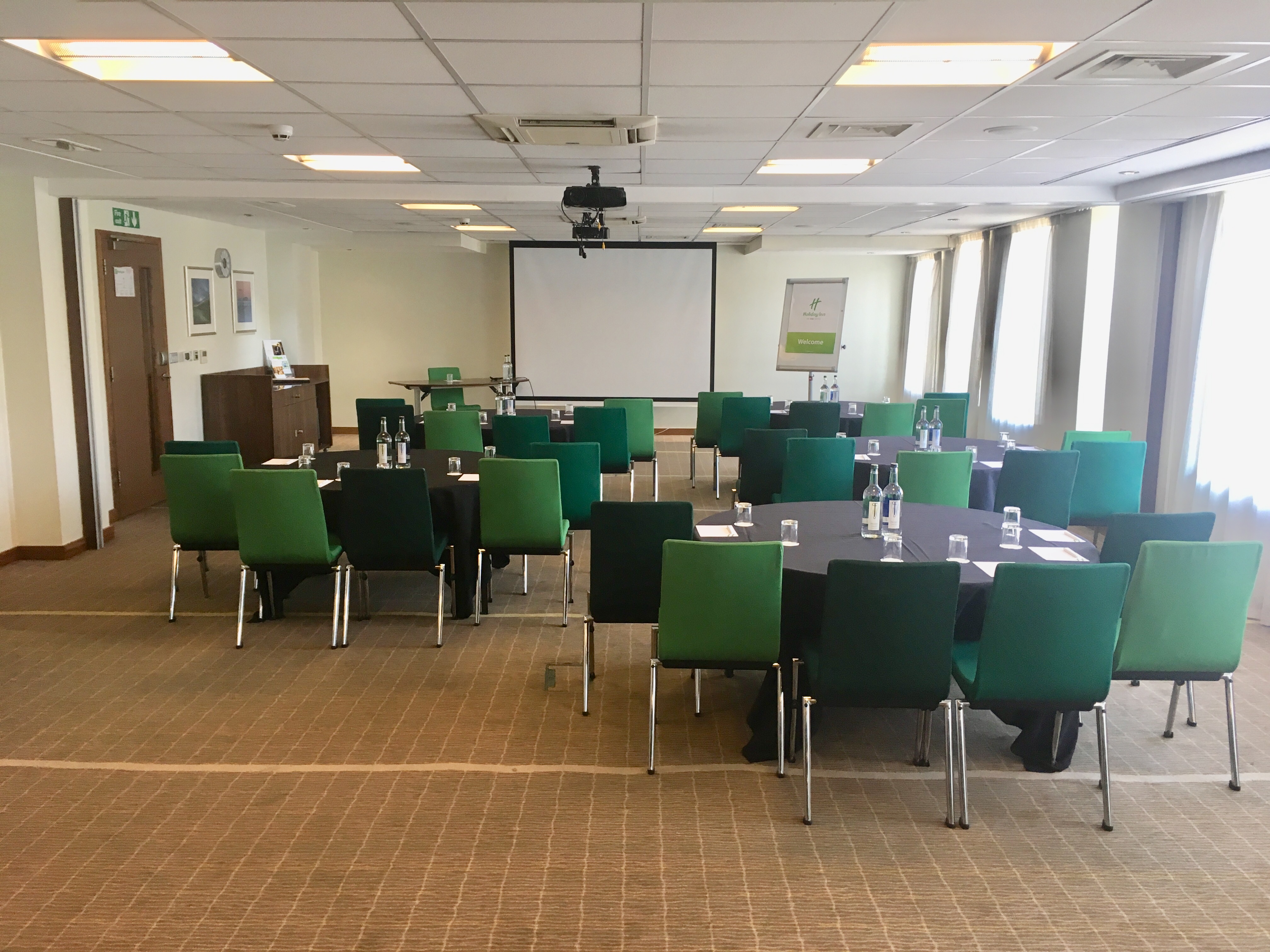 Meeting room at Holiday Inn Bristol with green chairs, ideal for professional events.