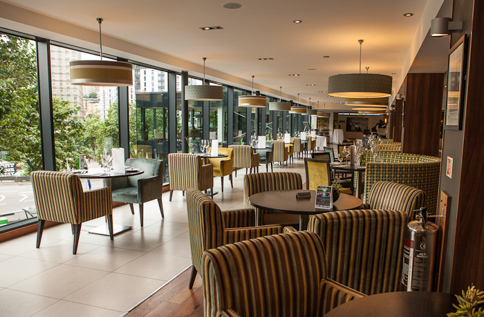 Modern meeting room with large windows at Holiday Inn Bristol City Centre for events.