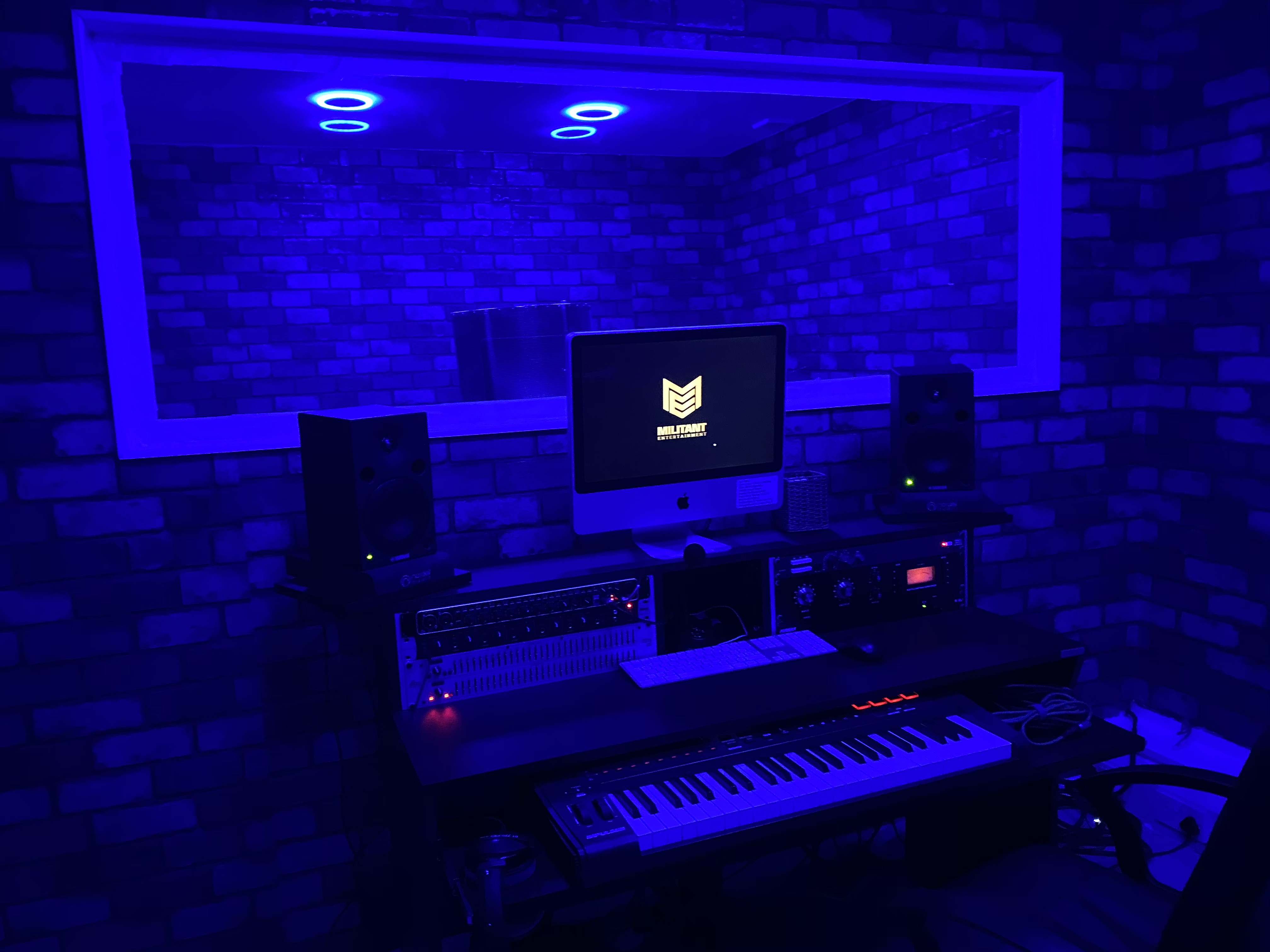 Modern recording studio with blue lighting, ideal for music events and workshops.