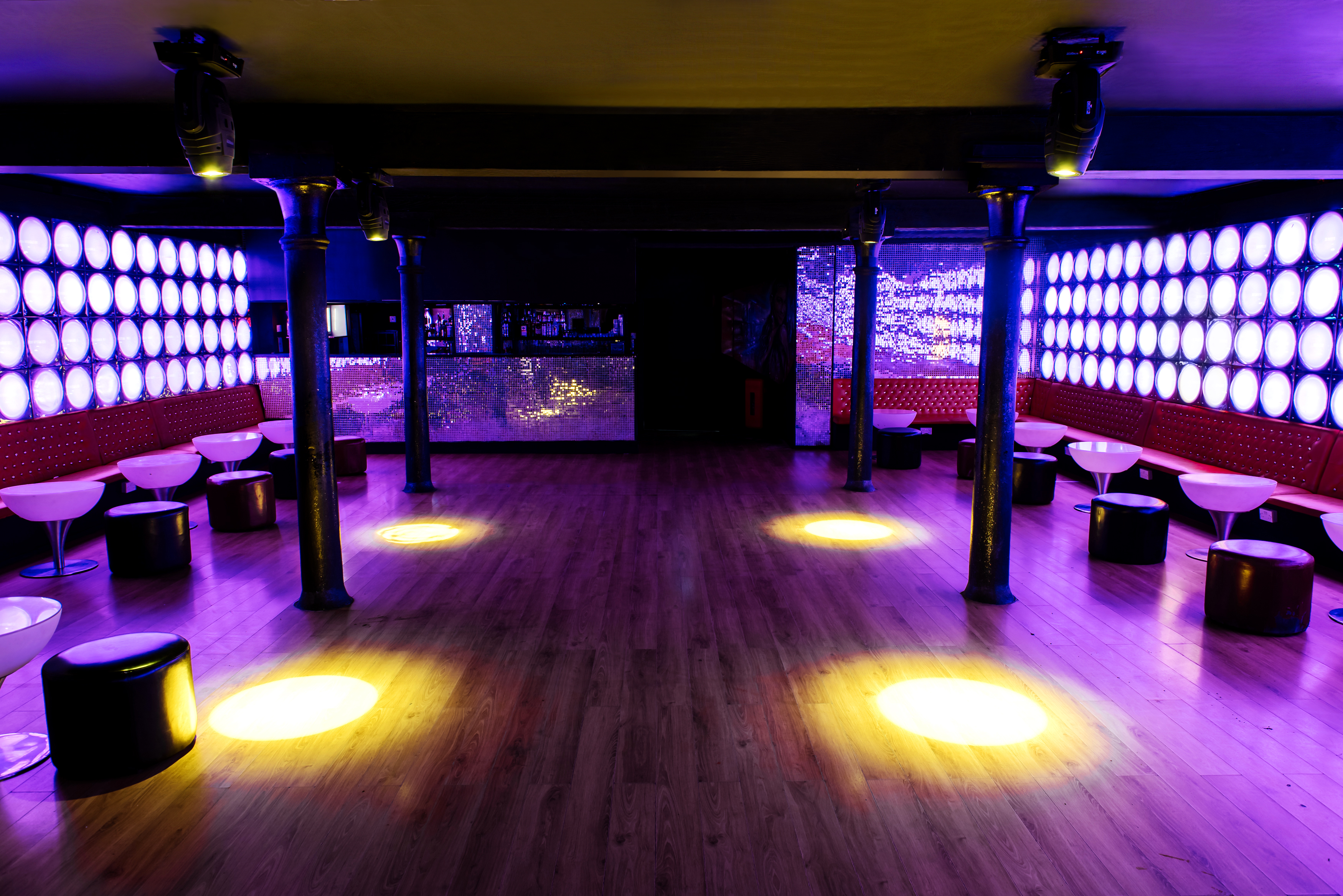 Modern event space with vibrant lighting and sleek design for dynamic gatherings.