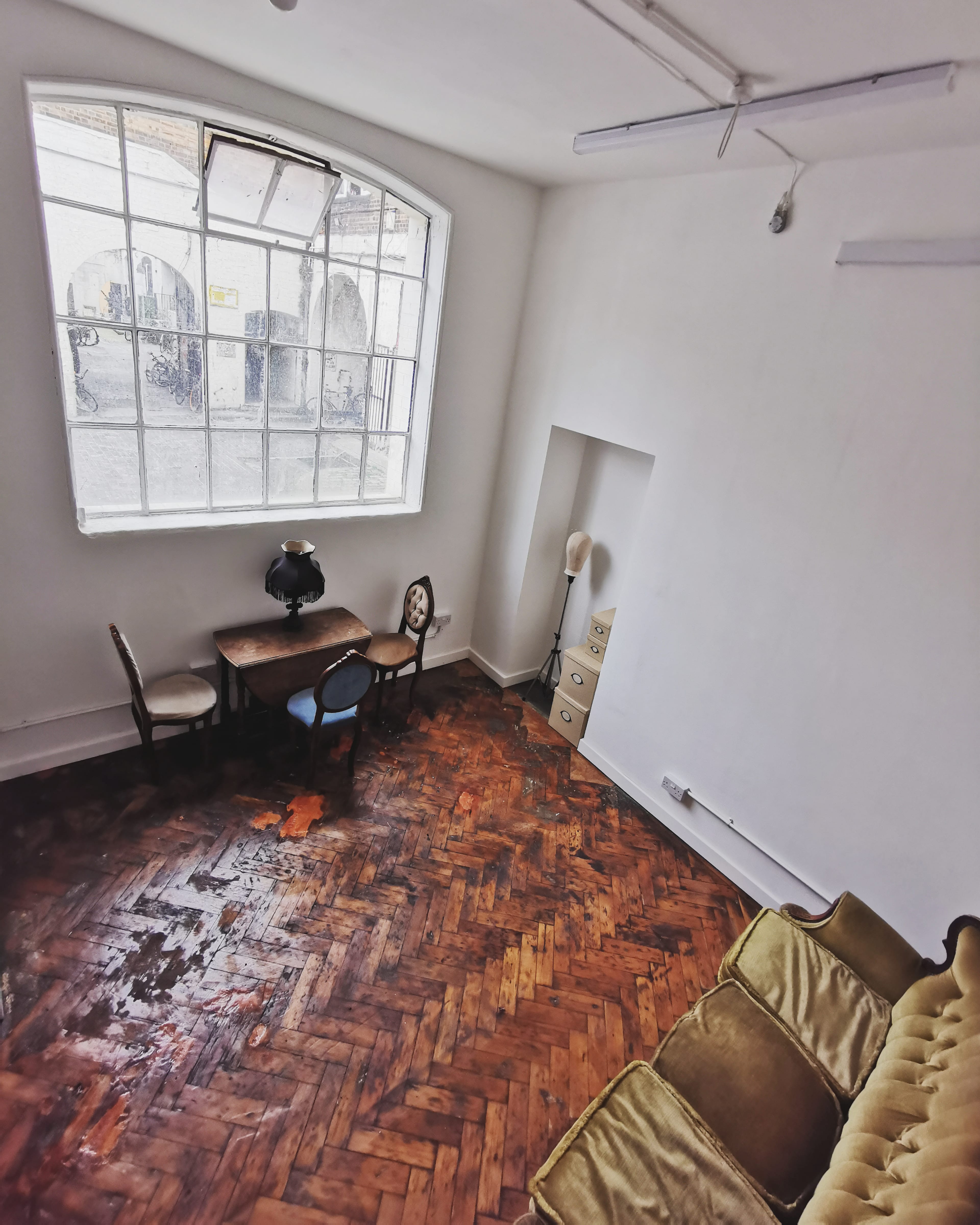 Minimalist meeting space with vintage decor in East London Arts Salon, ideal for gatherings.