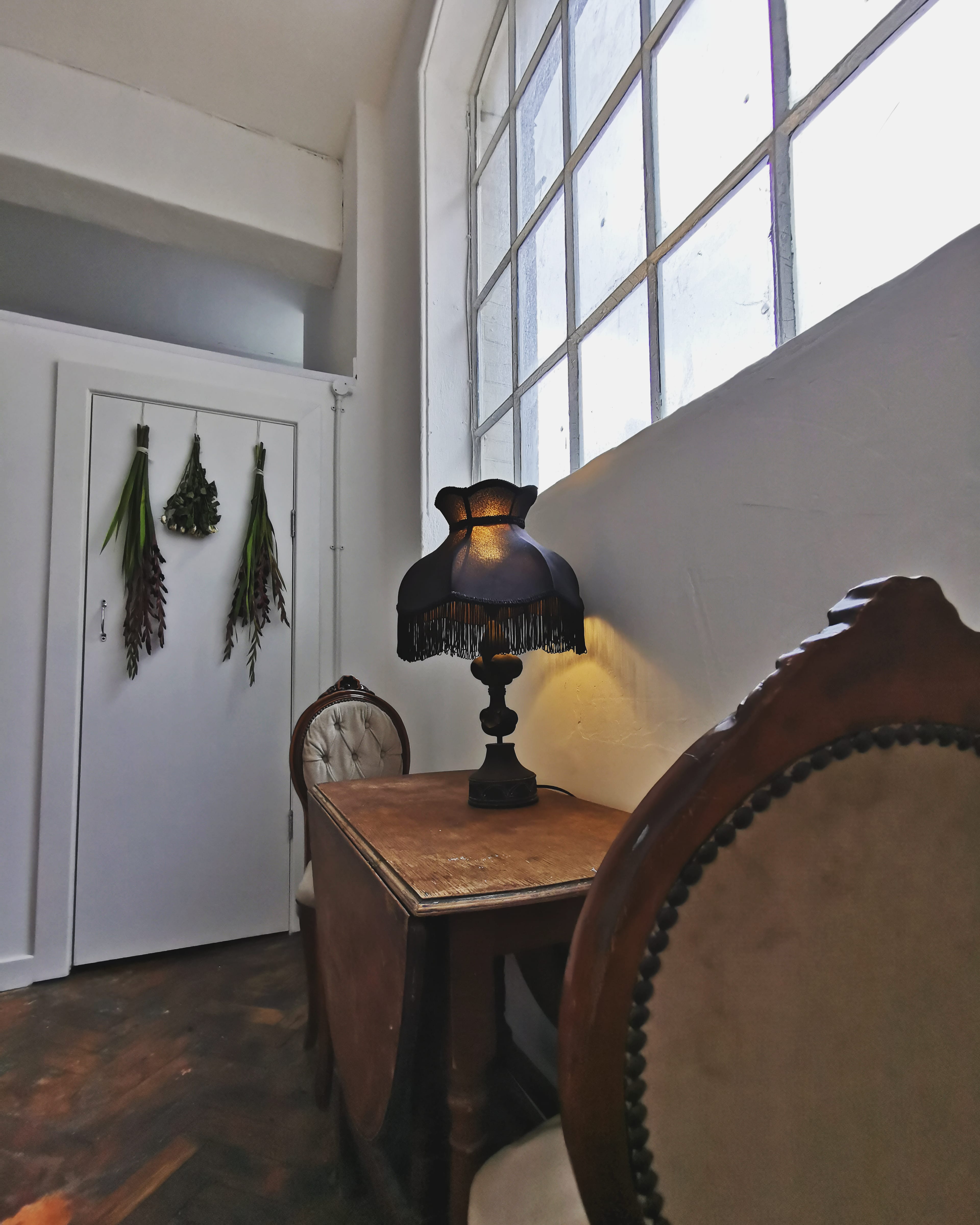 Cozy event space corner with vintage lamp, ideal for gatherings and networking in East London.