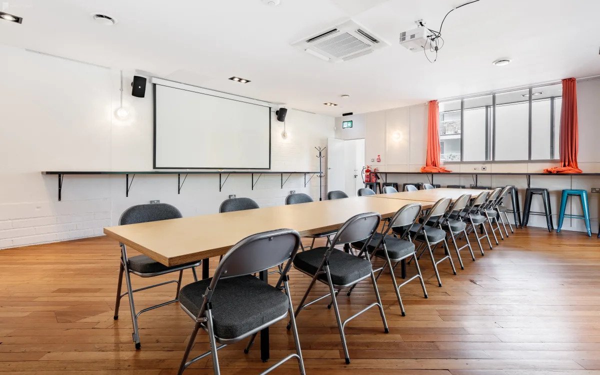 Versatile conference space with long table, ideal for workshops and team discussions.