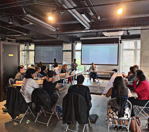 "Bright meeting room at OmStudio with engaged participants for effective collaboration."