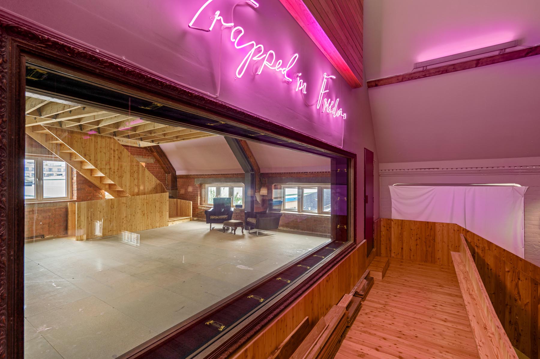 Versatile event space with large window, ideal for meetings and gatherings.