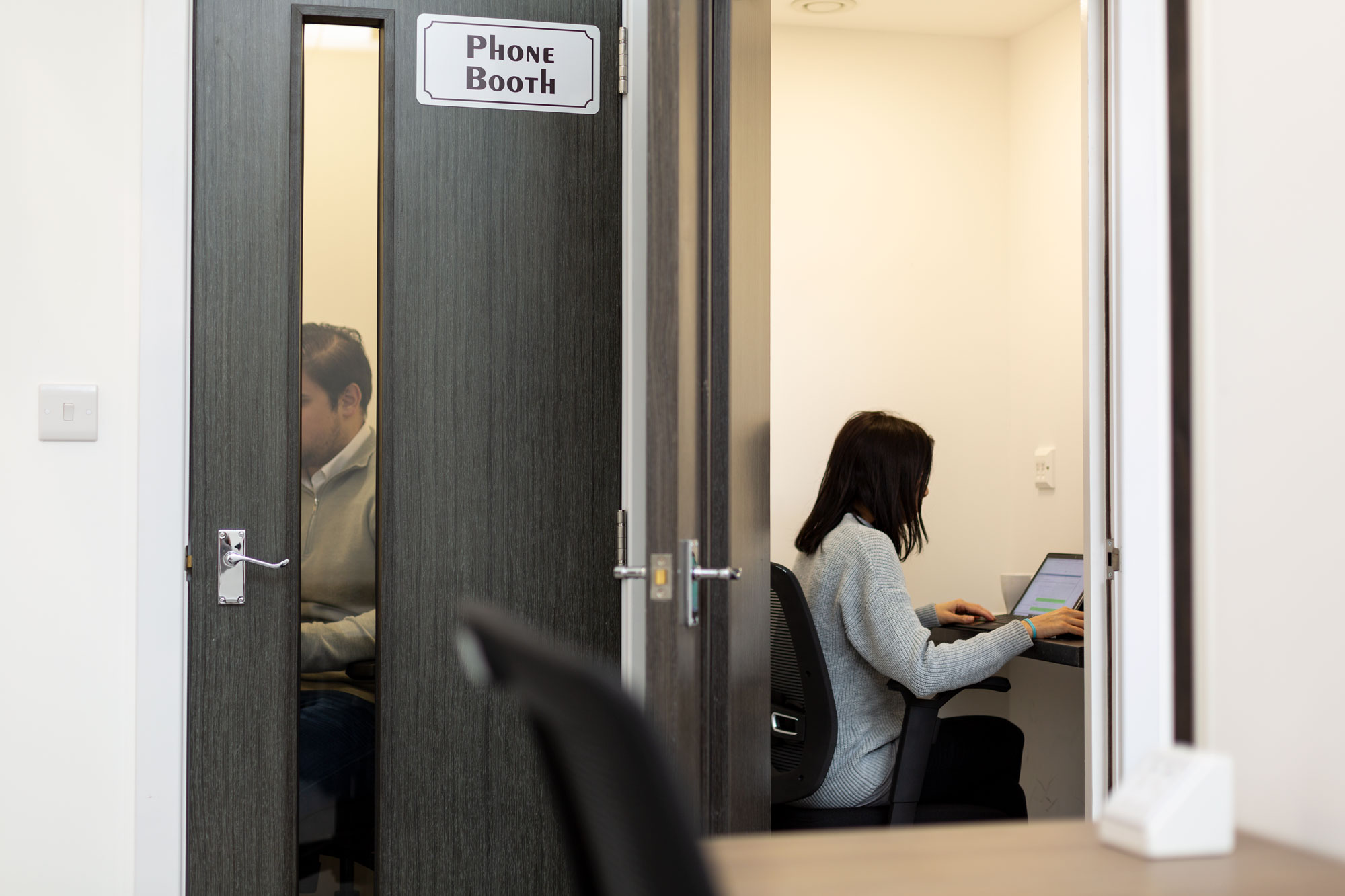 Modern workspace with phone booths for privacy in KOZMIK WORK SPACE, ideal for events.