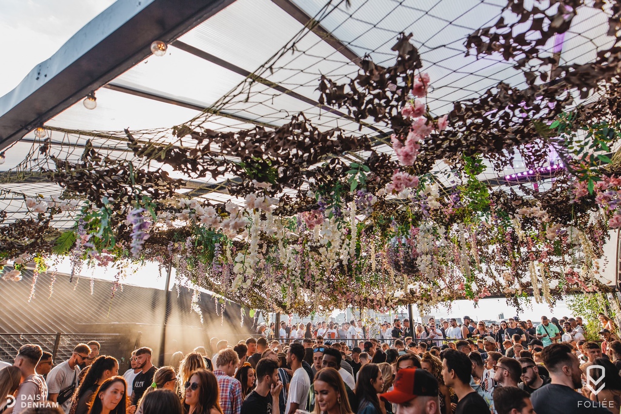 "Vibrant floral outdoor event space at XOYO Birmingham for networking and creativity."