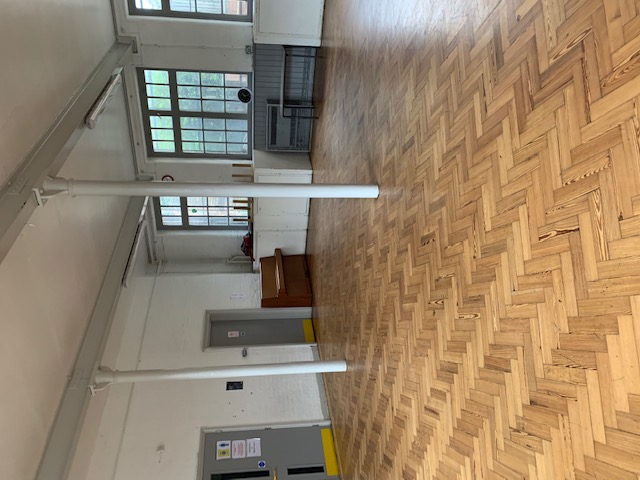 Spacious Lower Hall in Hargrave Hall with polished wood floors, ideal for workshops and gatherings.