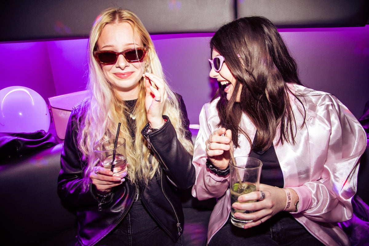 Private karaoke pods at Lucky Voice Islington with attendees enjoying a vibrant social event.