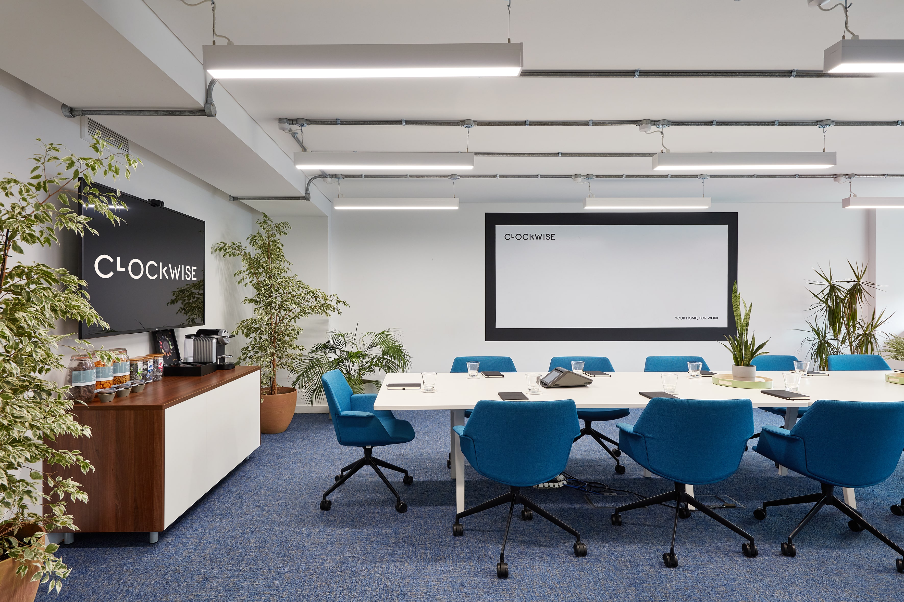 Modern meeting room in The Lagan Suite with blue chairs, ideal for collaboration and brainstorming.