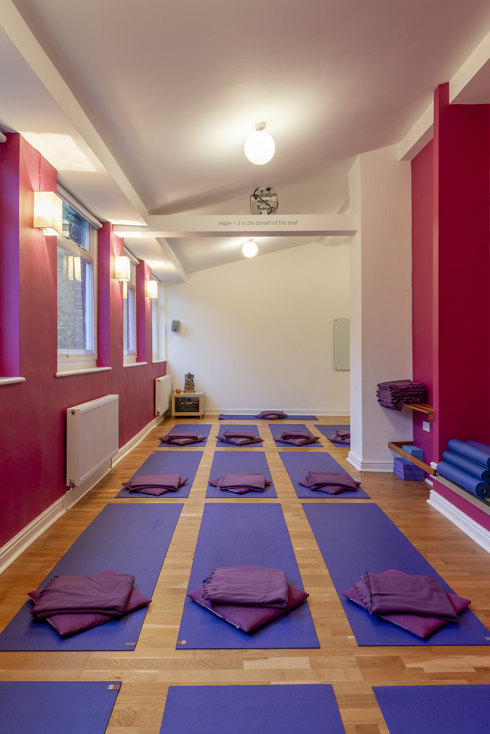 Serene yoga studio with organized mats for wellness retreats and mindfulness workshops.