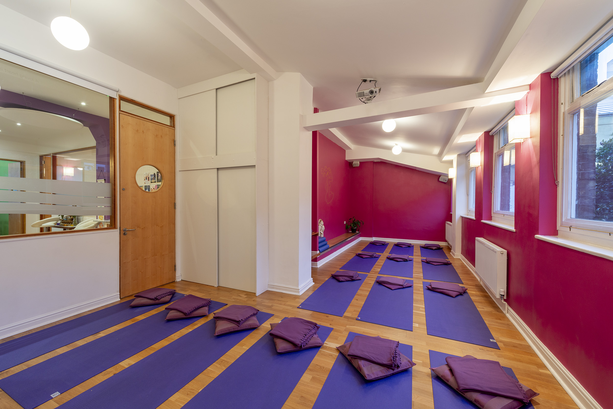 Serene yoga studio with natural light, perfect for wellness retreats and mindfulness workshops.