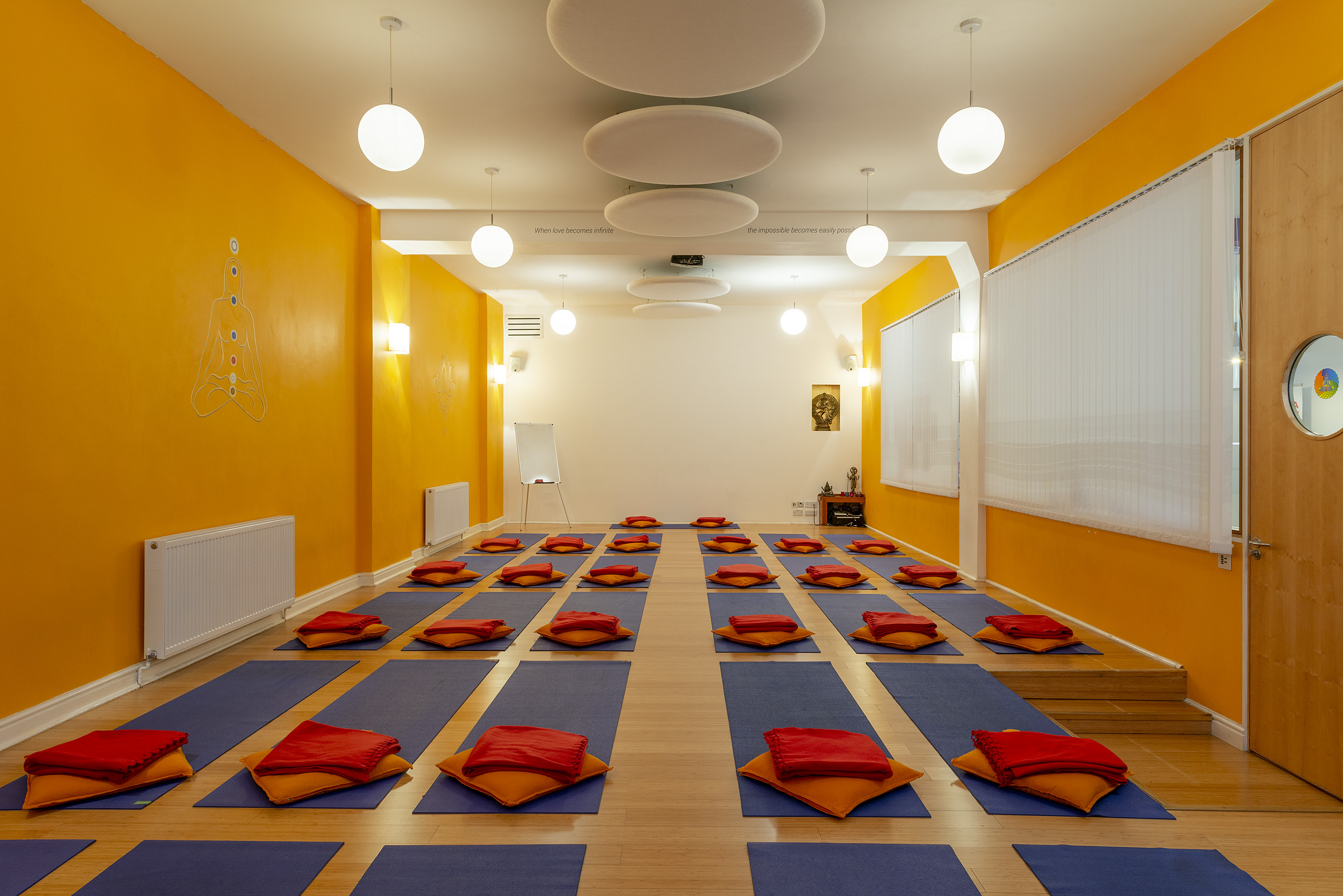 Serene yoga studio with orange walls, ideal for wellness retreats and mindfulness workshops.