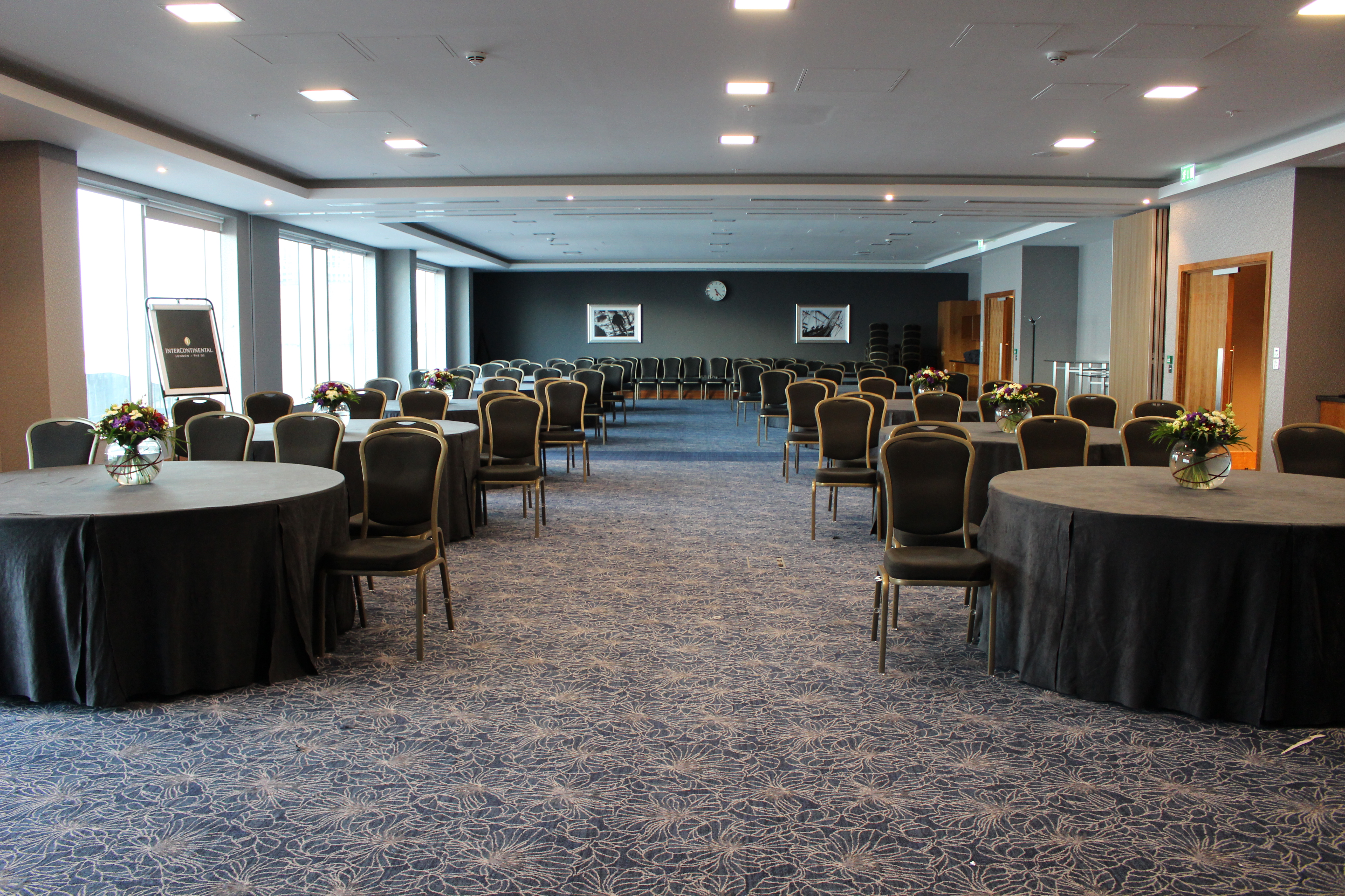 Spacious event room at Greenwich Suites, ideal for meetings and banquets with floral decor.
