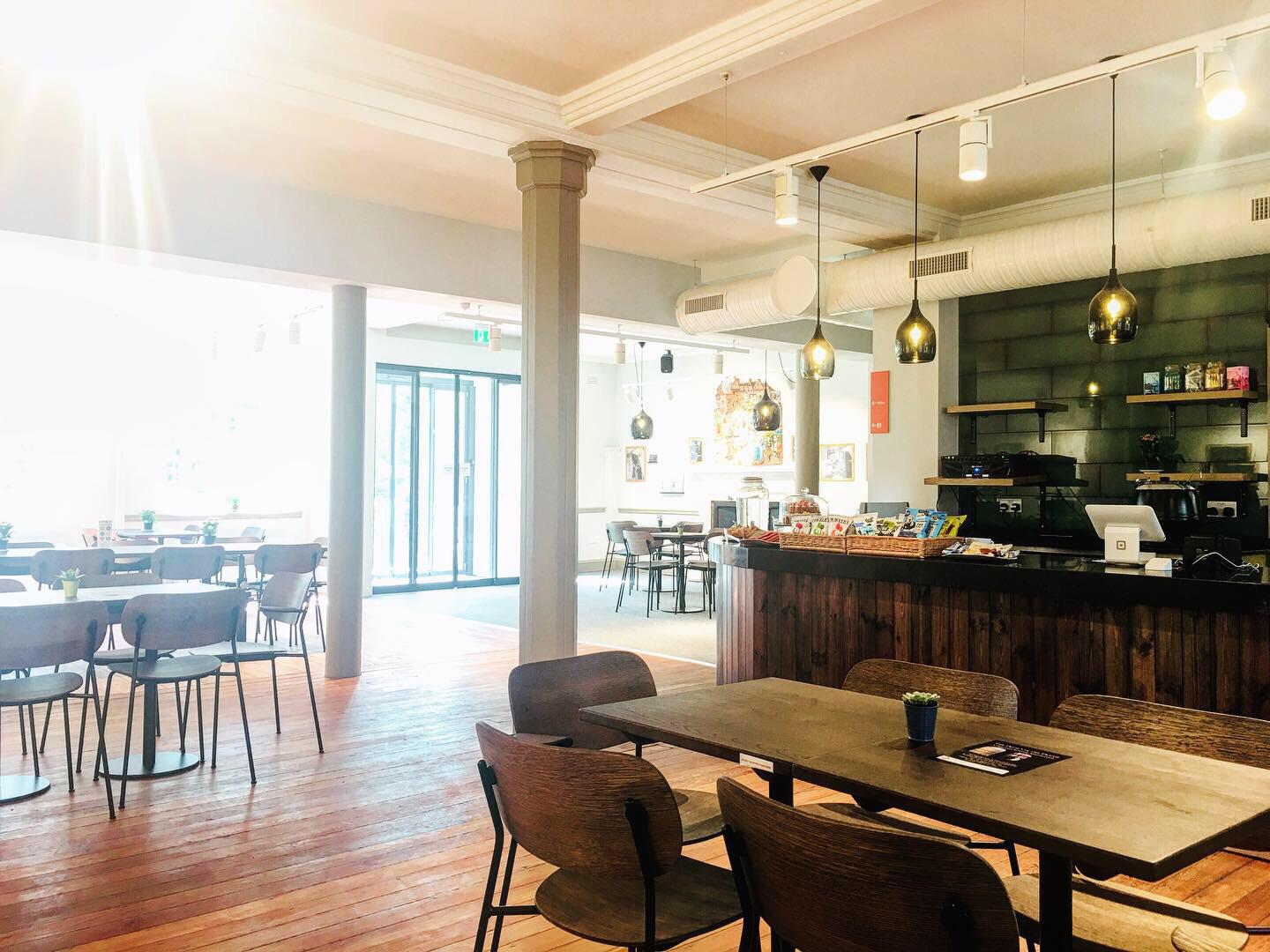 Modern café in Oxford House with warm wood accents, perfect for networking events.
