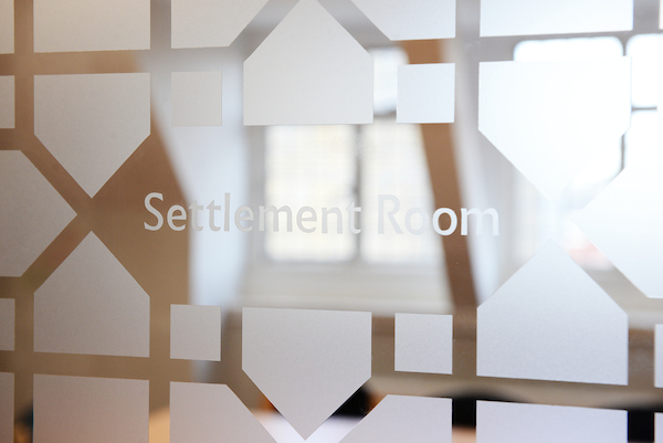 "Frosted glass door of Settlement Room, ideal for meetings and events in Oxford House."