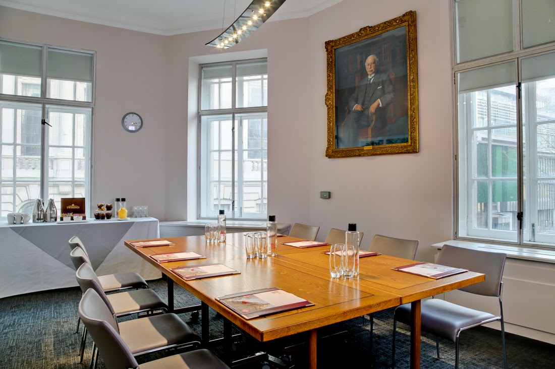 Charles Parsons in a bright meeting room with a wooden table, ideal for professional gatherings.