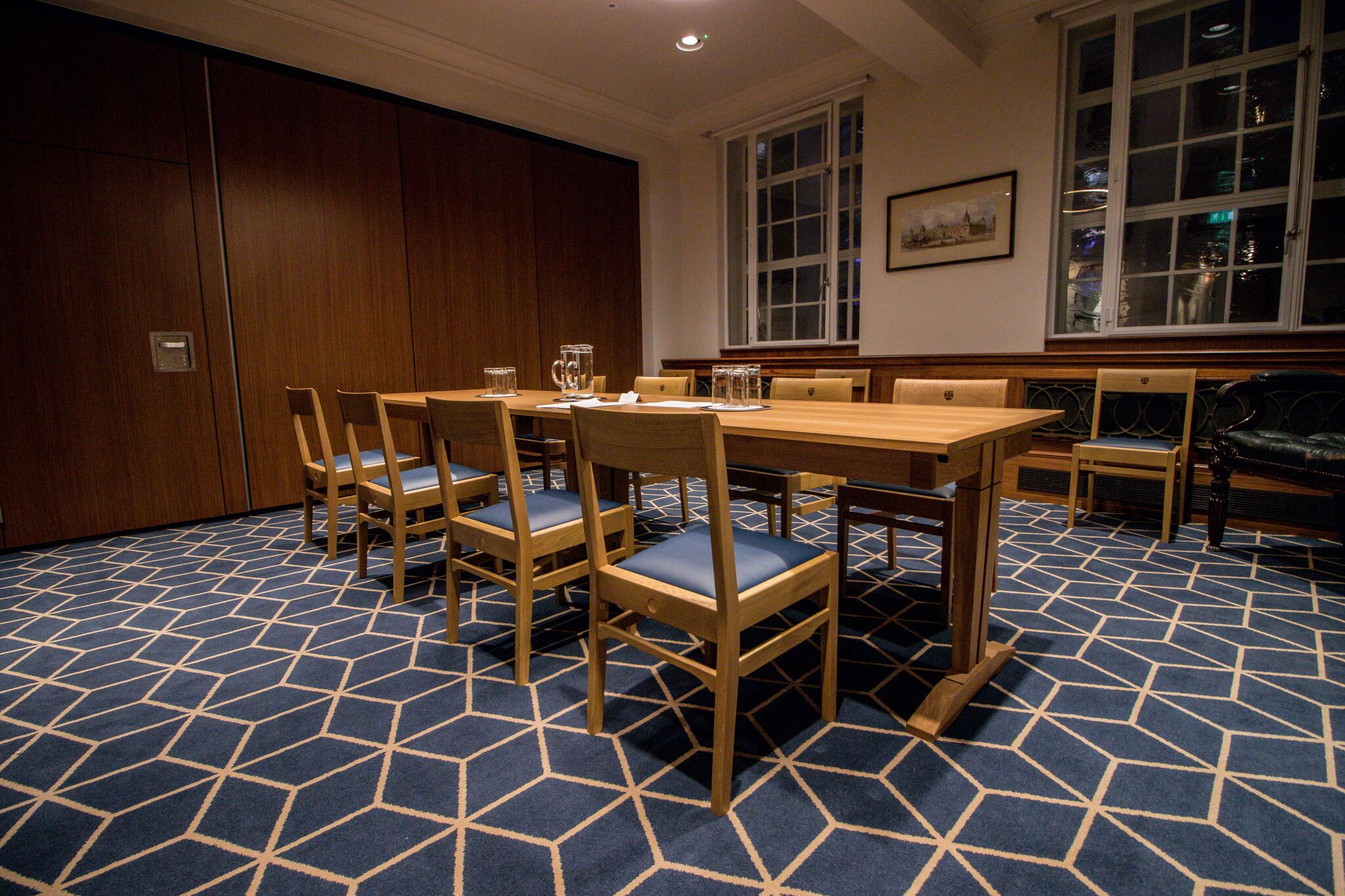 Meeting room with wooden table, ideal for corporate meetings and small events.