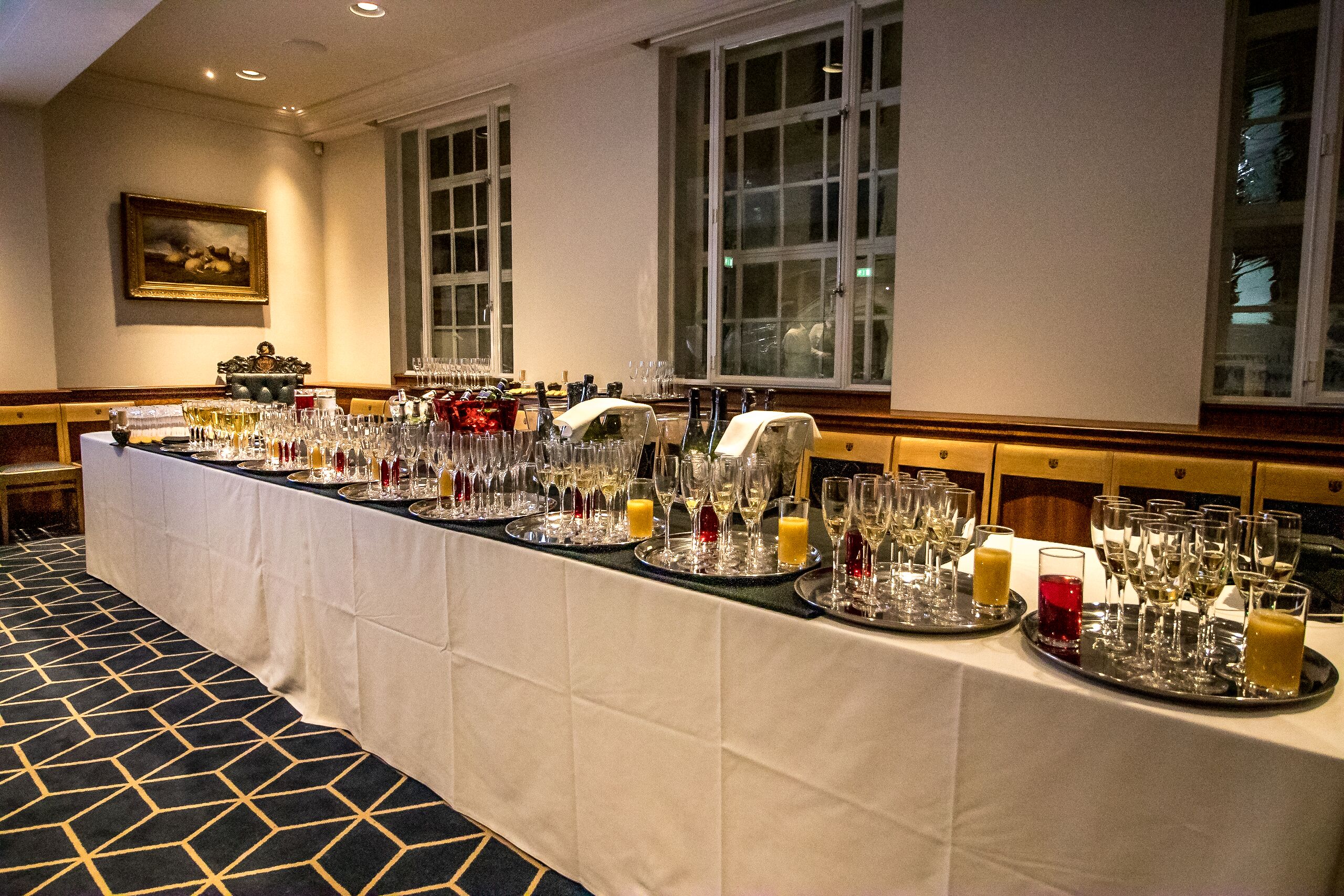 Beverage station at Court Suites, featuring elegant glassware for networking events.
