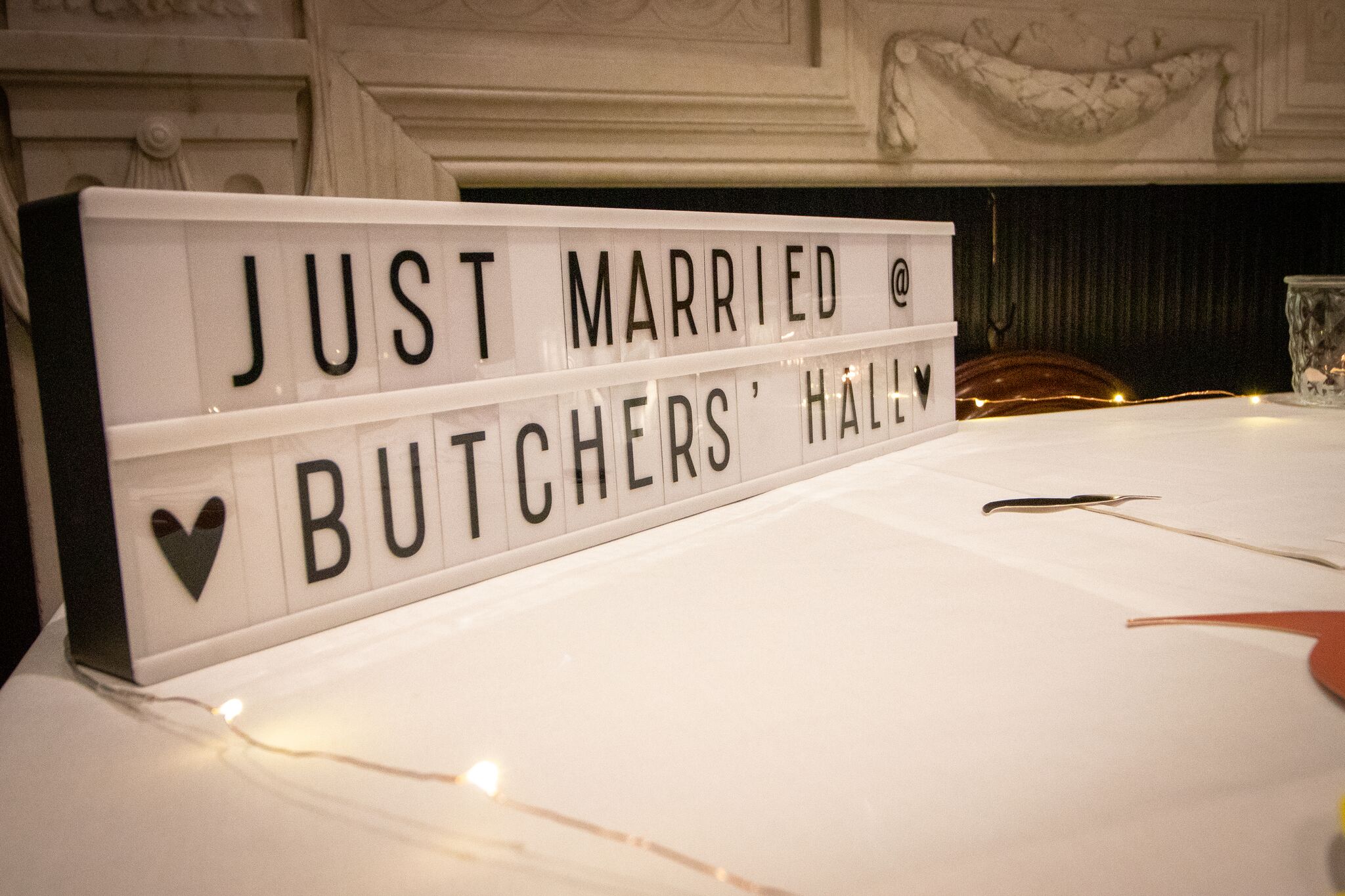 Charming wedding setup at Court Suites with "Just Married" lightbox sign.