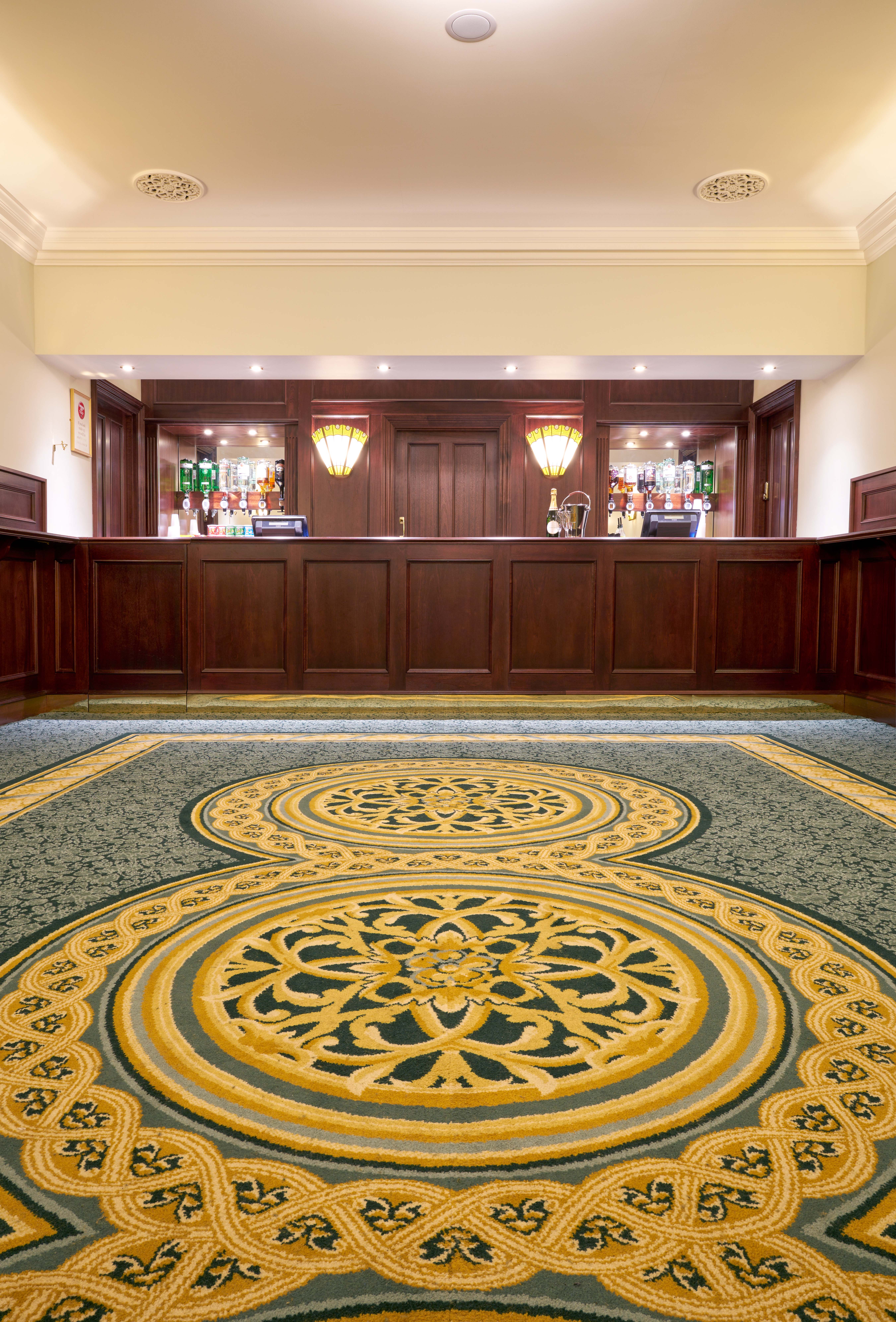 Aldwych Theatre Auditorium bar with rich wood paneling, ideal for networking events.