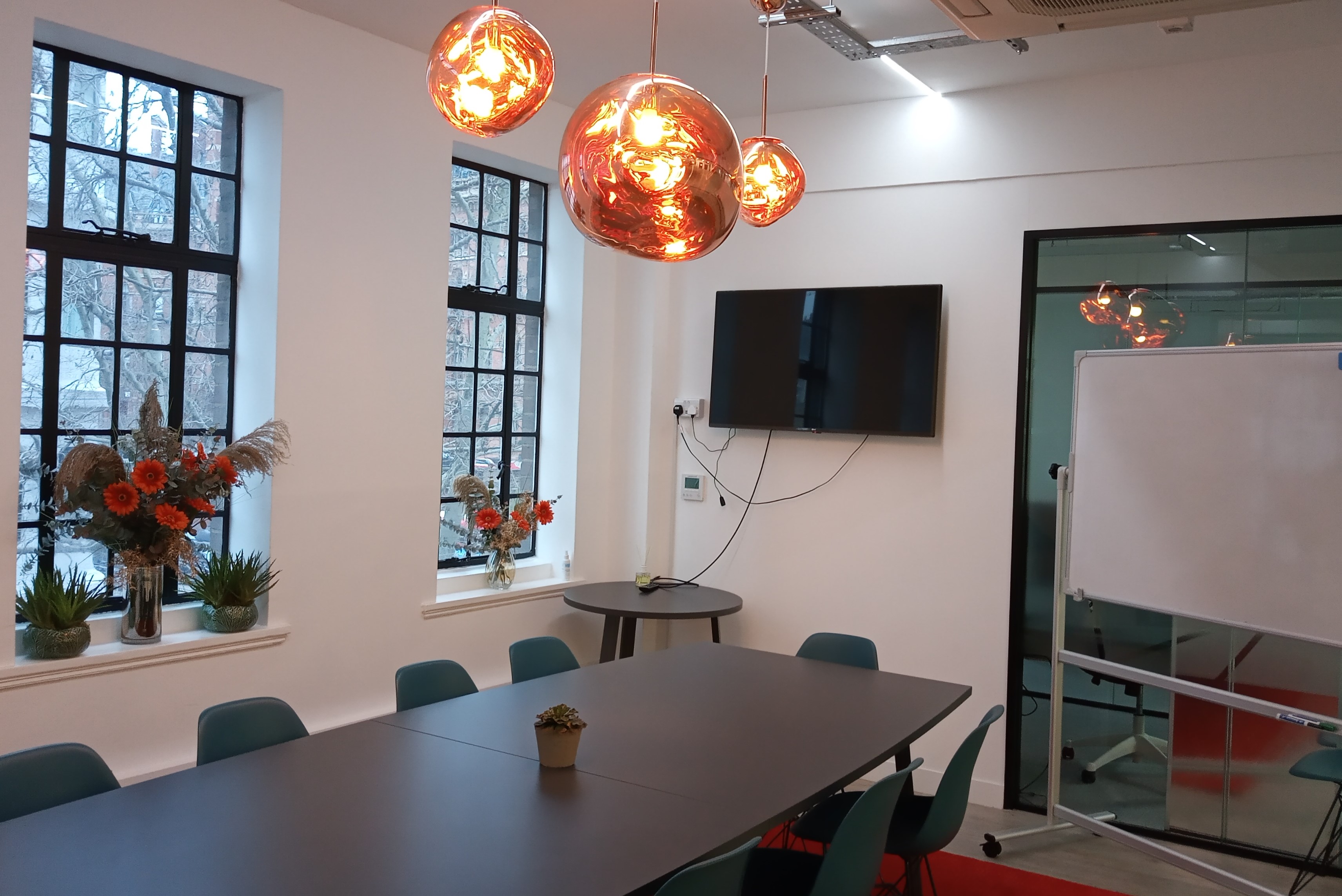 Modern Tom Dixon Boardroom with long table, ideal for meetings and workshops.