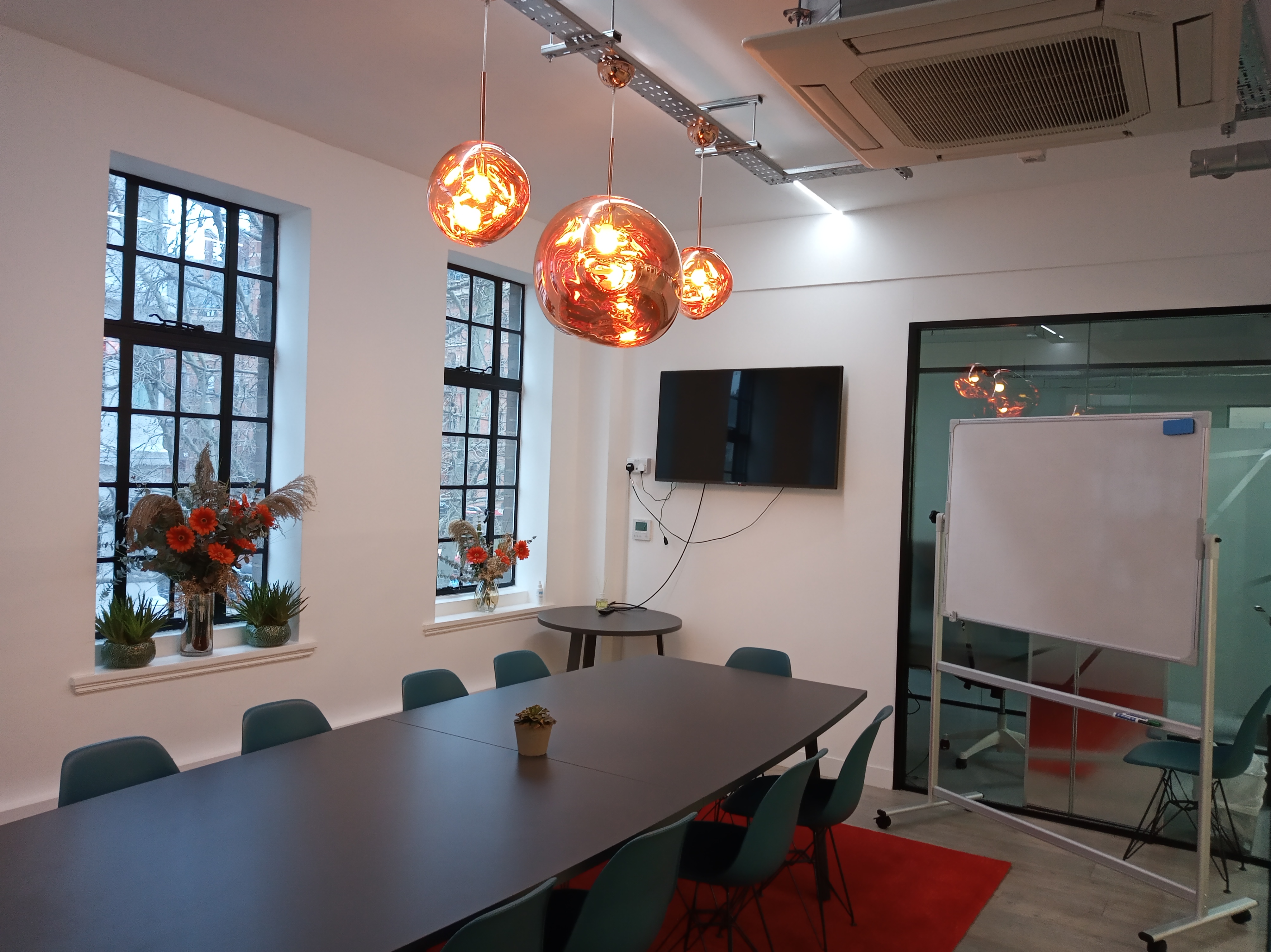 Modern Tom Dixon Boardroom with long table, ideal for meetings and presentations.