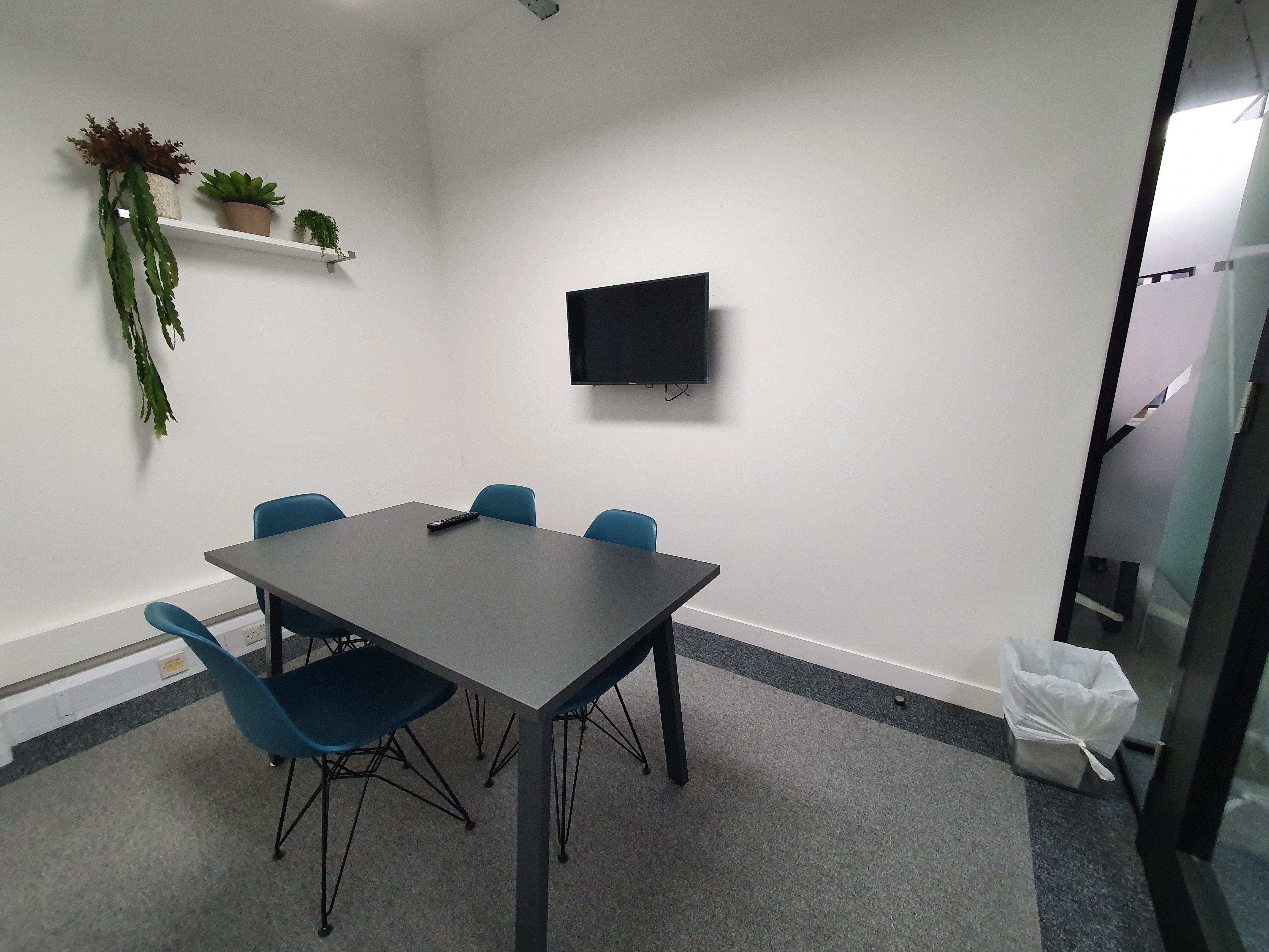 Jimmy Green Meeting Room: modern space with sleek table for productive meetings and brainstorming.