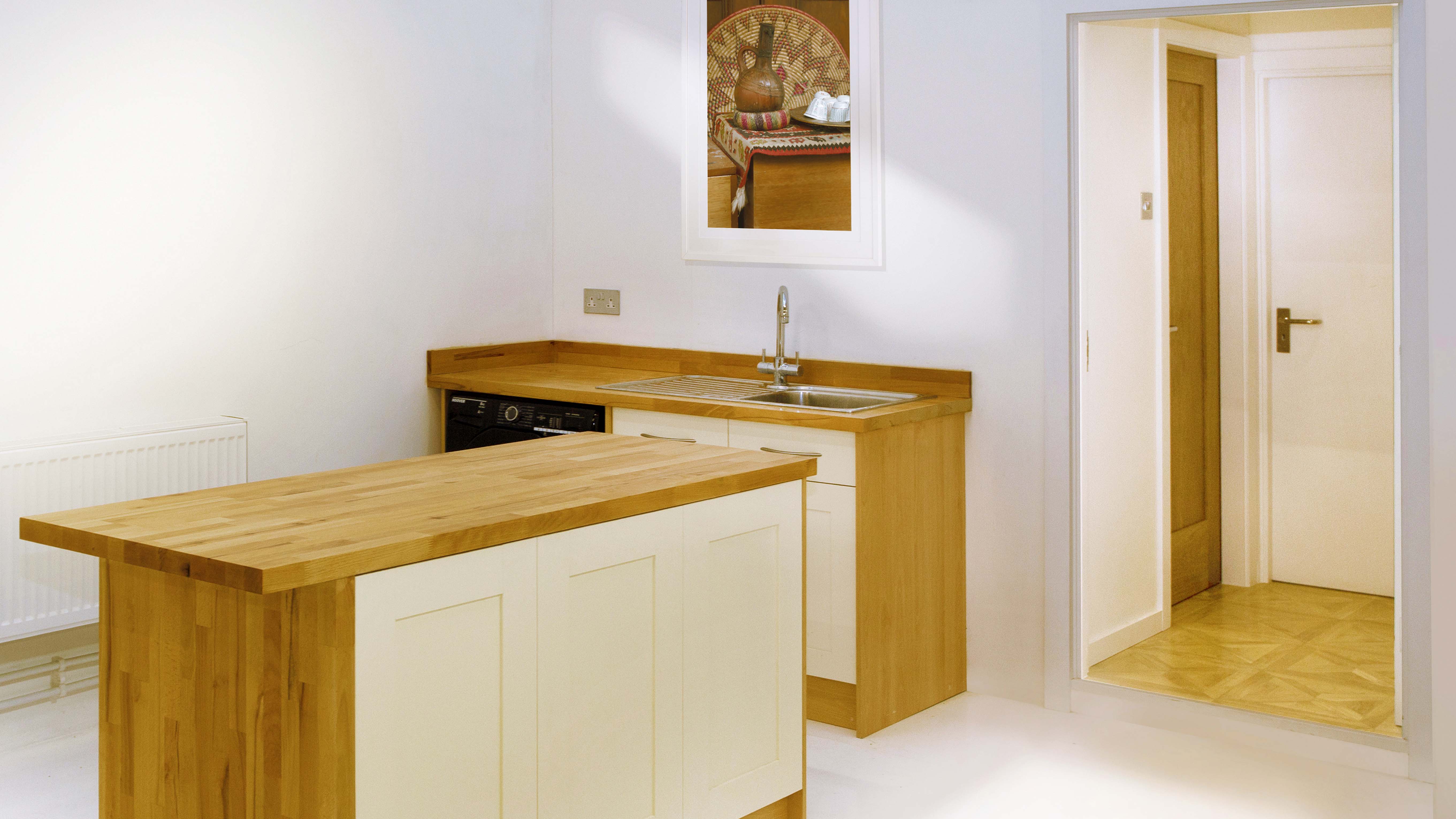 Modern kitchen venue with warm wood accents for intimate gatherings and catering events.