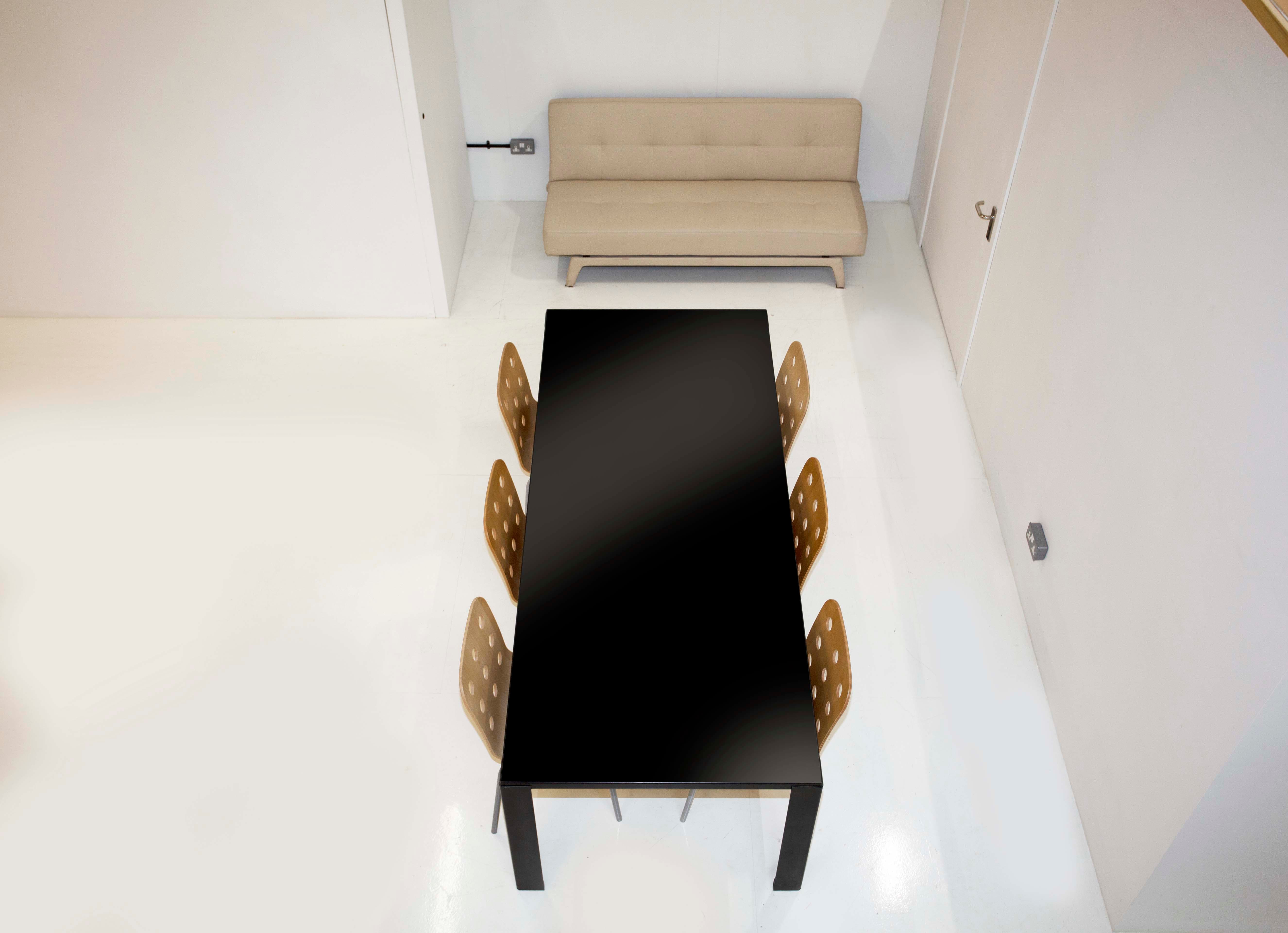 Modern meeting space with black table and stylish chairs in Des Fildes Hire Studio.