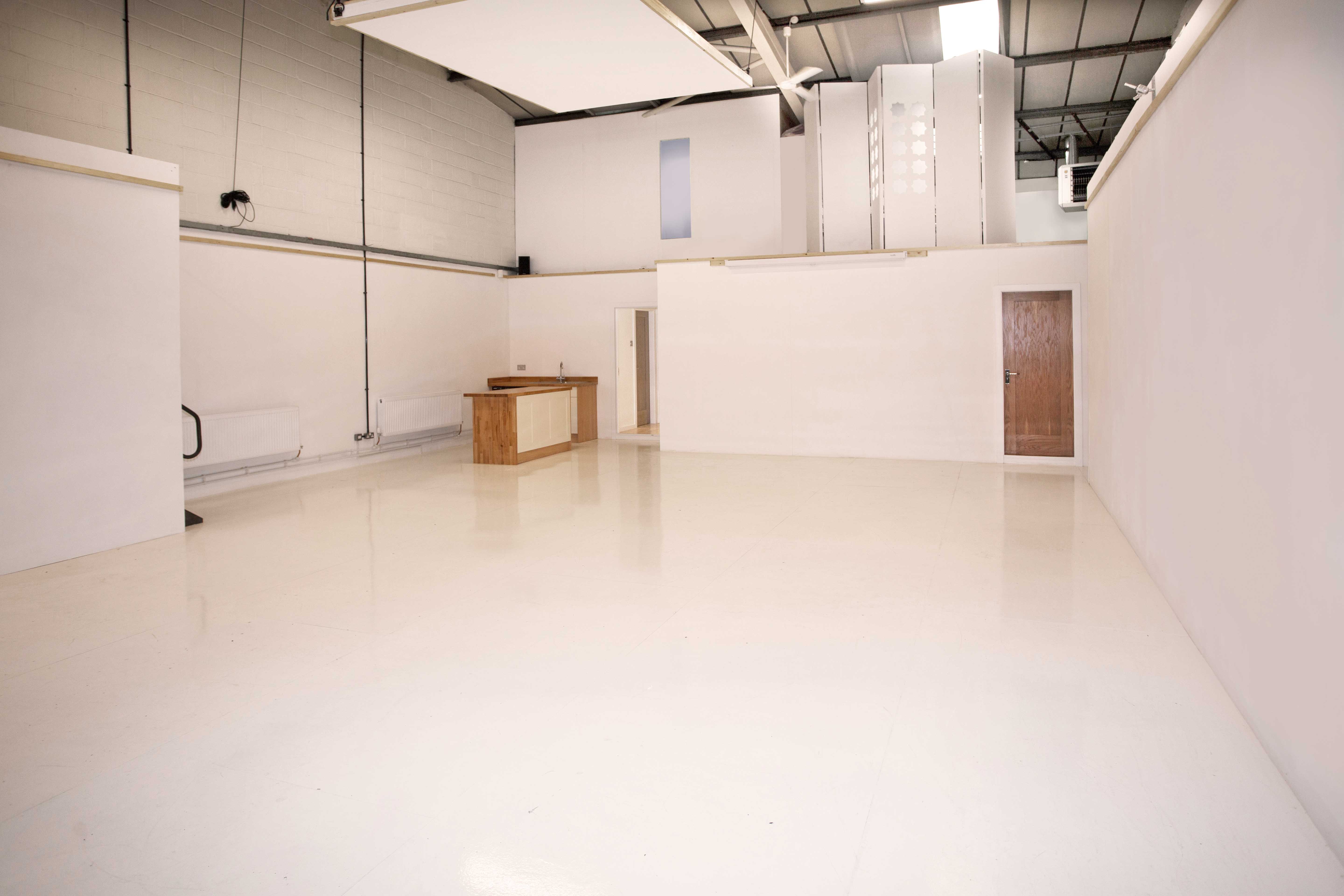 Versatile event space with clean white walls, ideal for meetings and workshops.