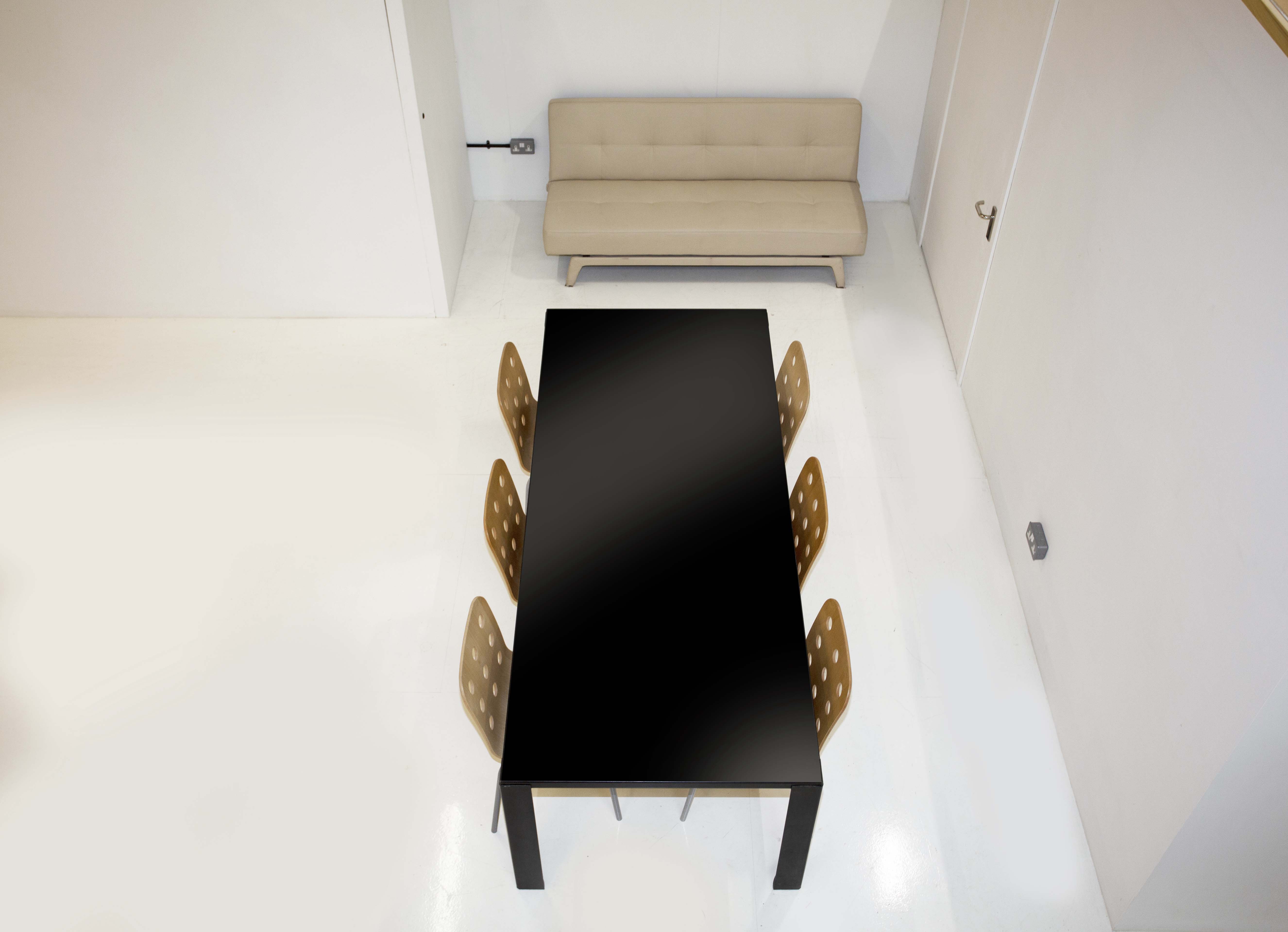 Modern meeting space with black table and stylish chairs in Des Fildes Hire Studio.