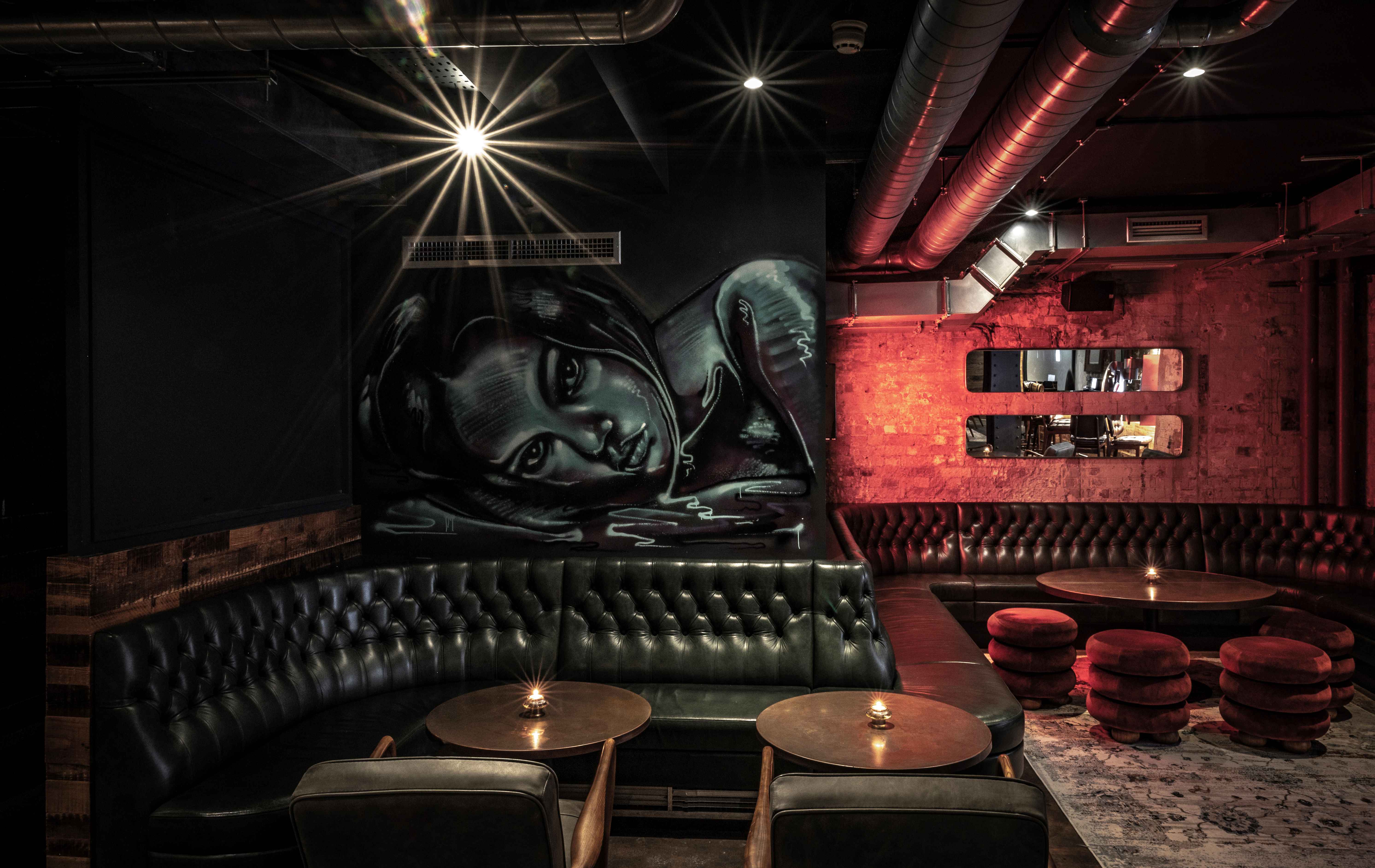Stylish private bar with moody lighting, perfect for networking events and gatherings.