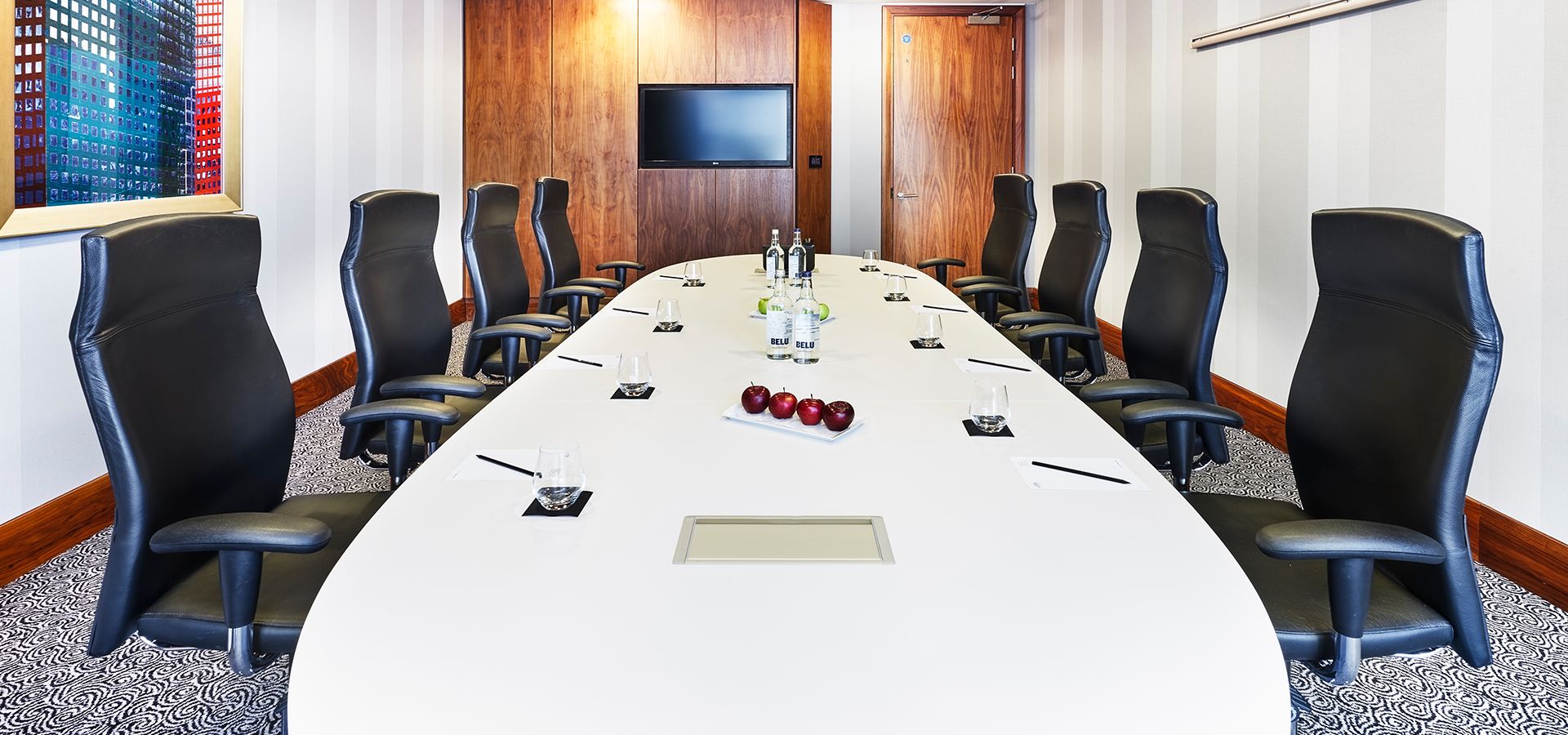 Modern conference room at Hotel La Tour with oval table for corporate meetings.